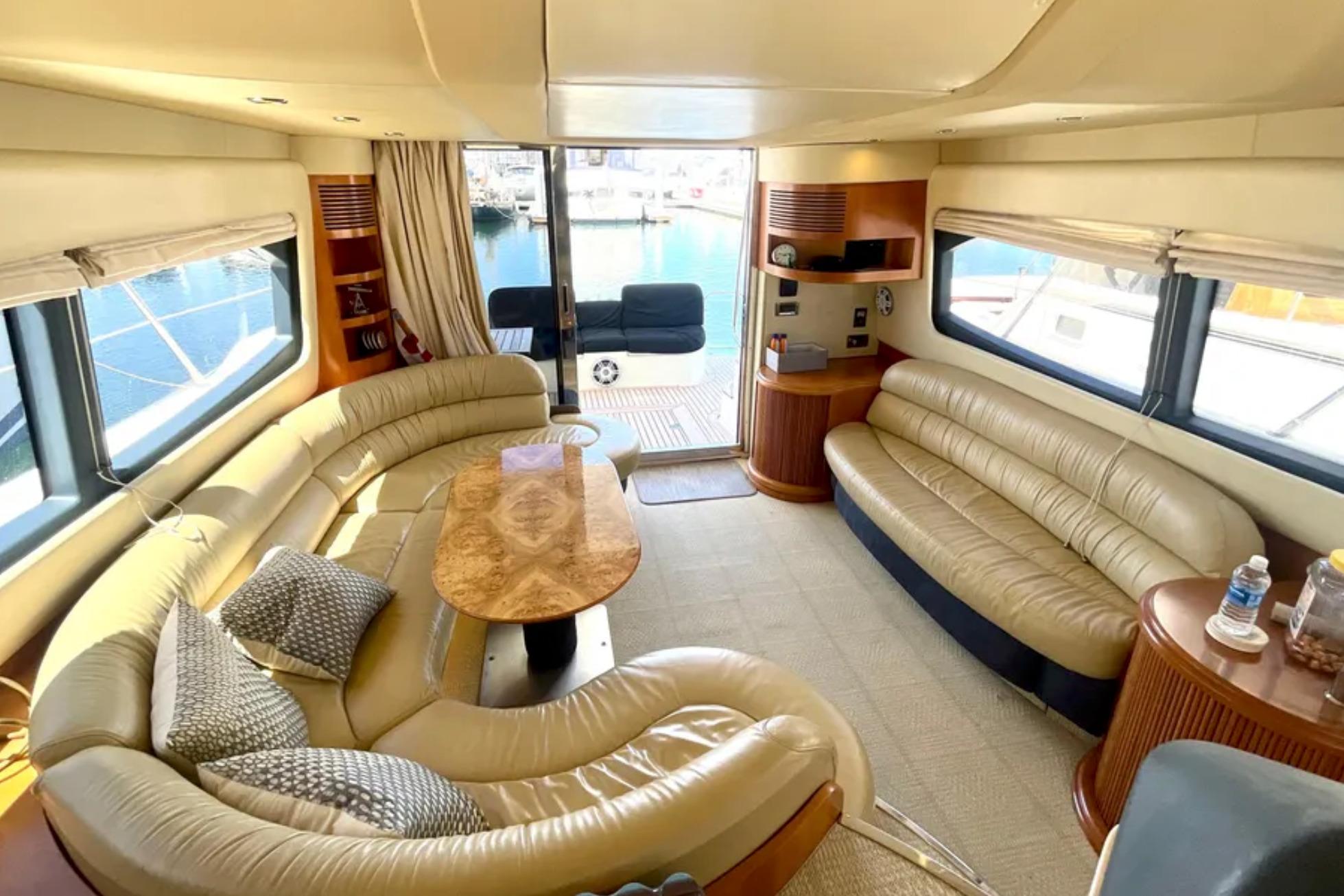 Luxurious interior of a 2004 Azimut 46 yacht with elegant leather seating and wooden accents.