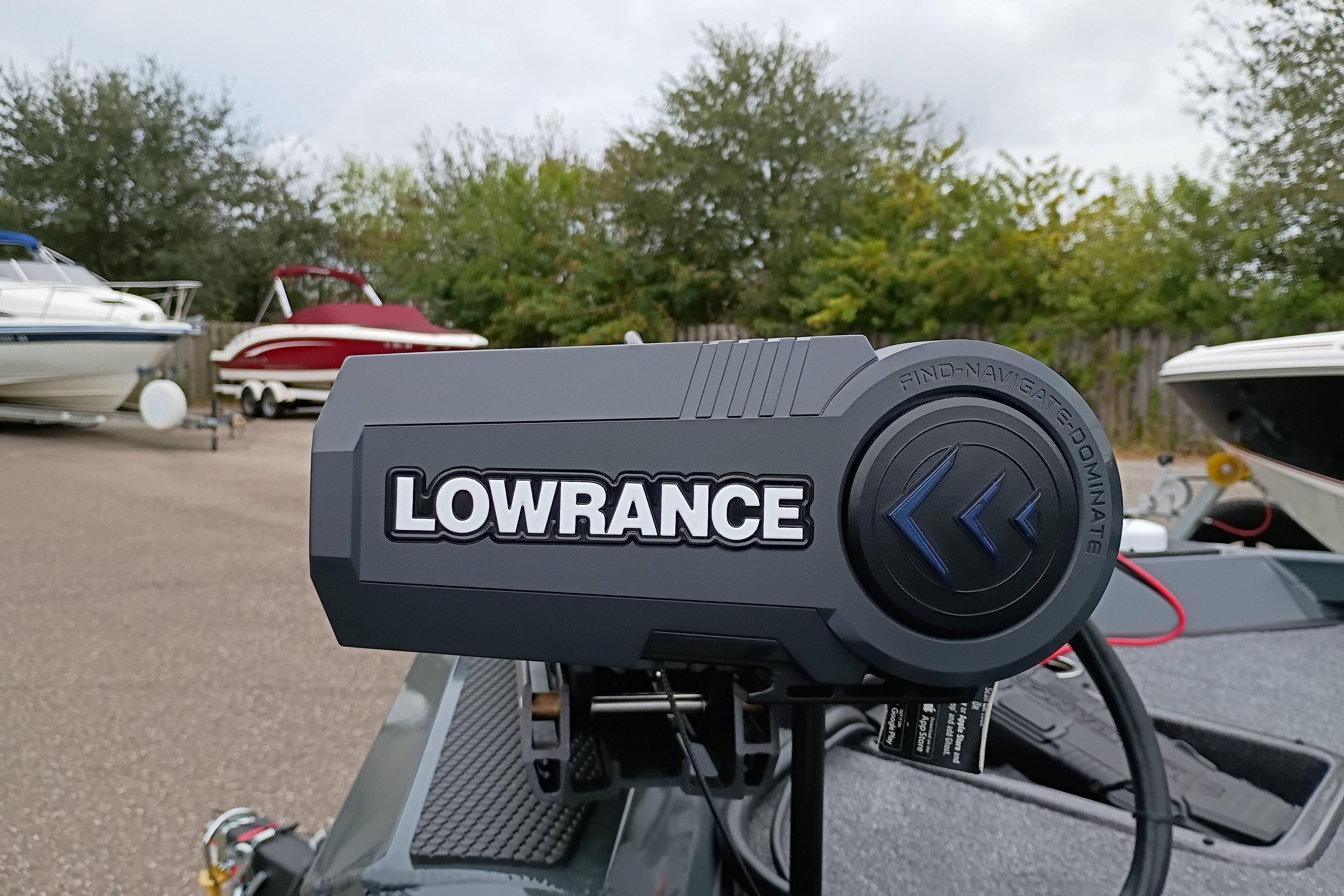 Lowrance device on 2026 Ranger RT198P boat, surrounded by other boats in a lot.
