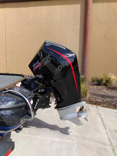 2025 Nitro Z19 boat with powerful outboard motor, parked on concrete surface.