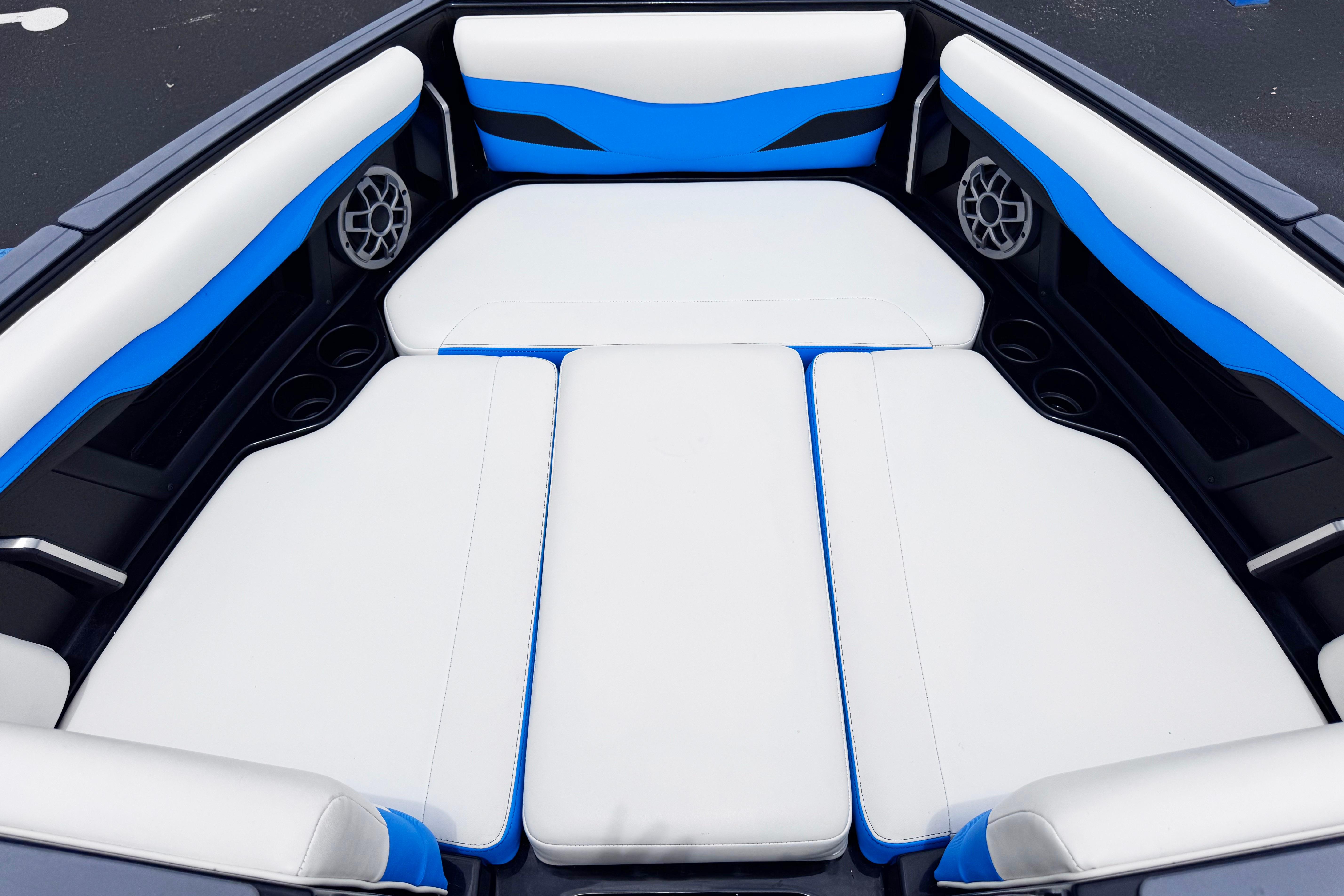 Interior of 2022 Axis T220 boat with blue and white seating.