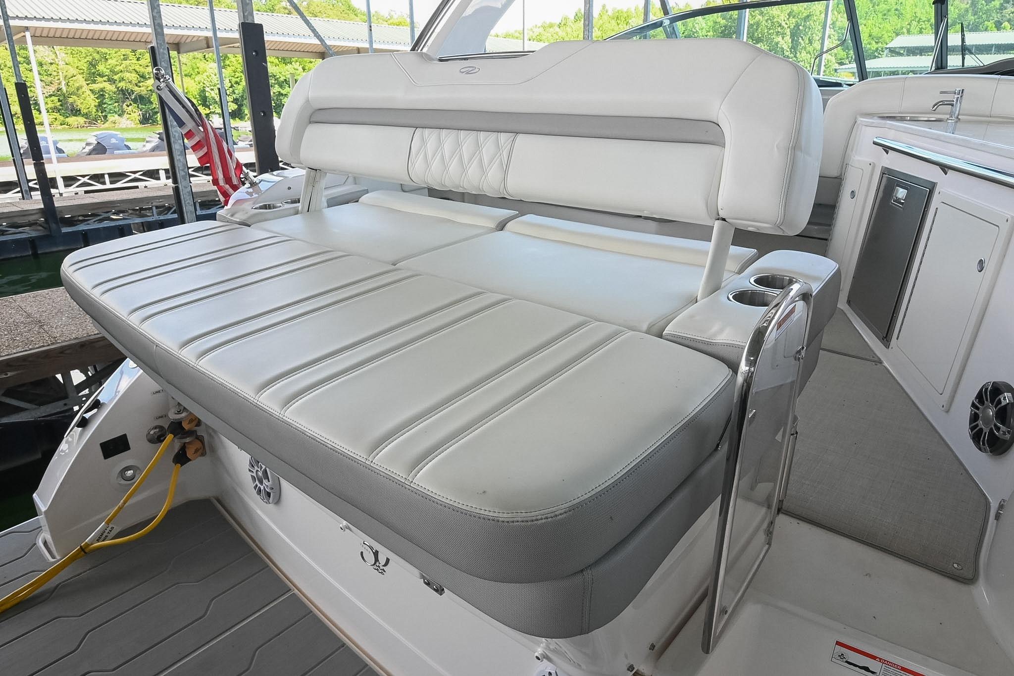 2021 Regal 33 Express boat interior with white cushioned seating and cup holders.