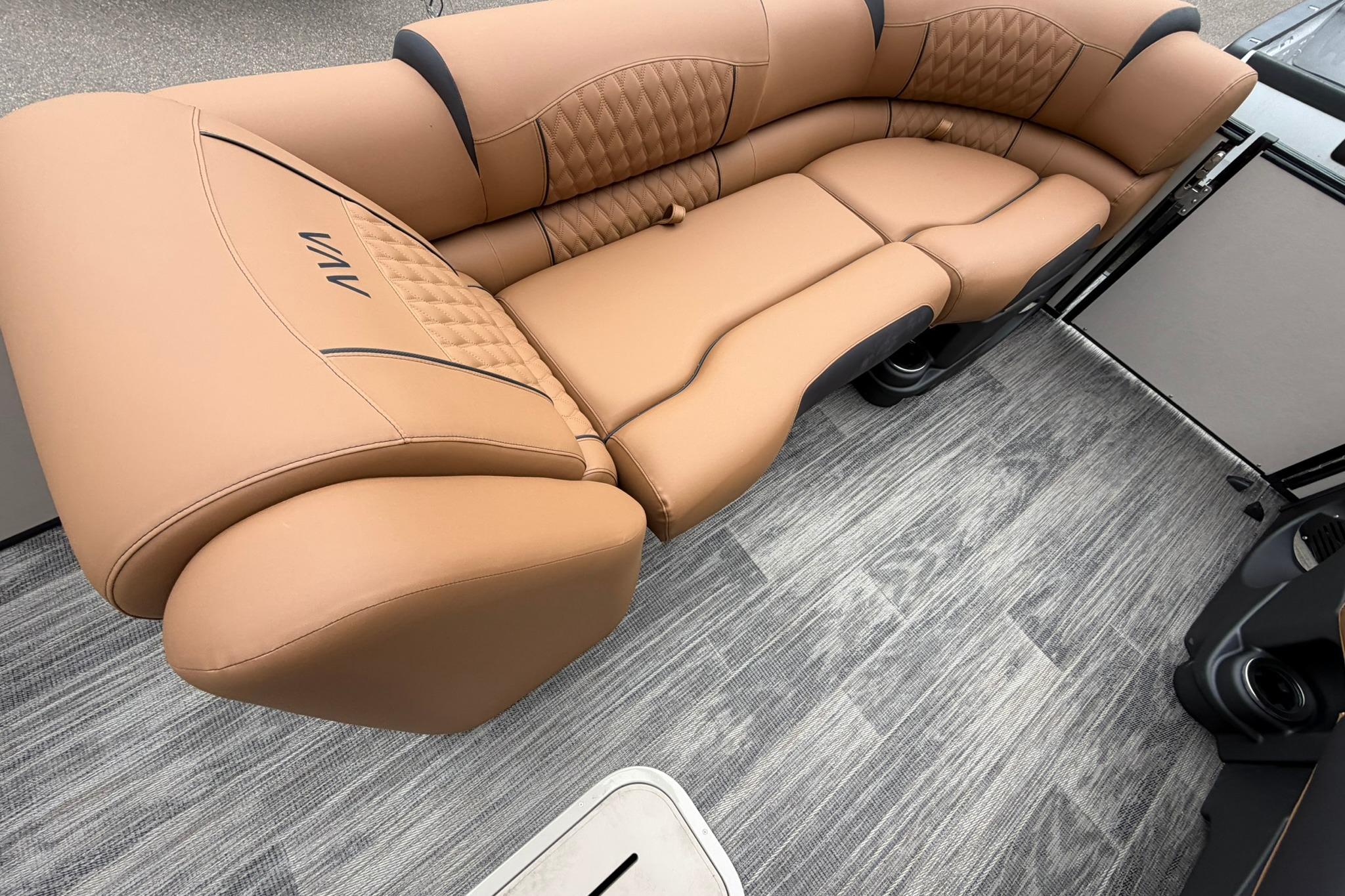 Luxurious tan seating on 2026 Avalon Catalina Quad Lounge boat, featuring elegant flooring.