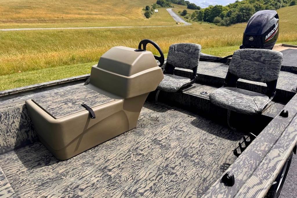 2026 Tracker Grizzly 1754 SC boat interior with camo seats and steering console.