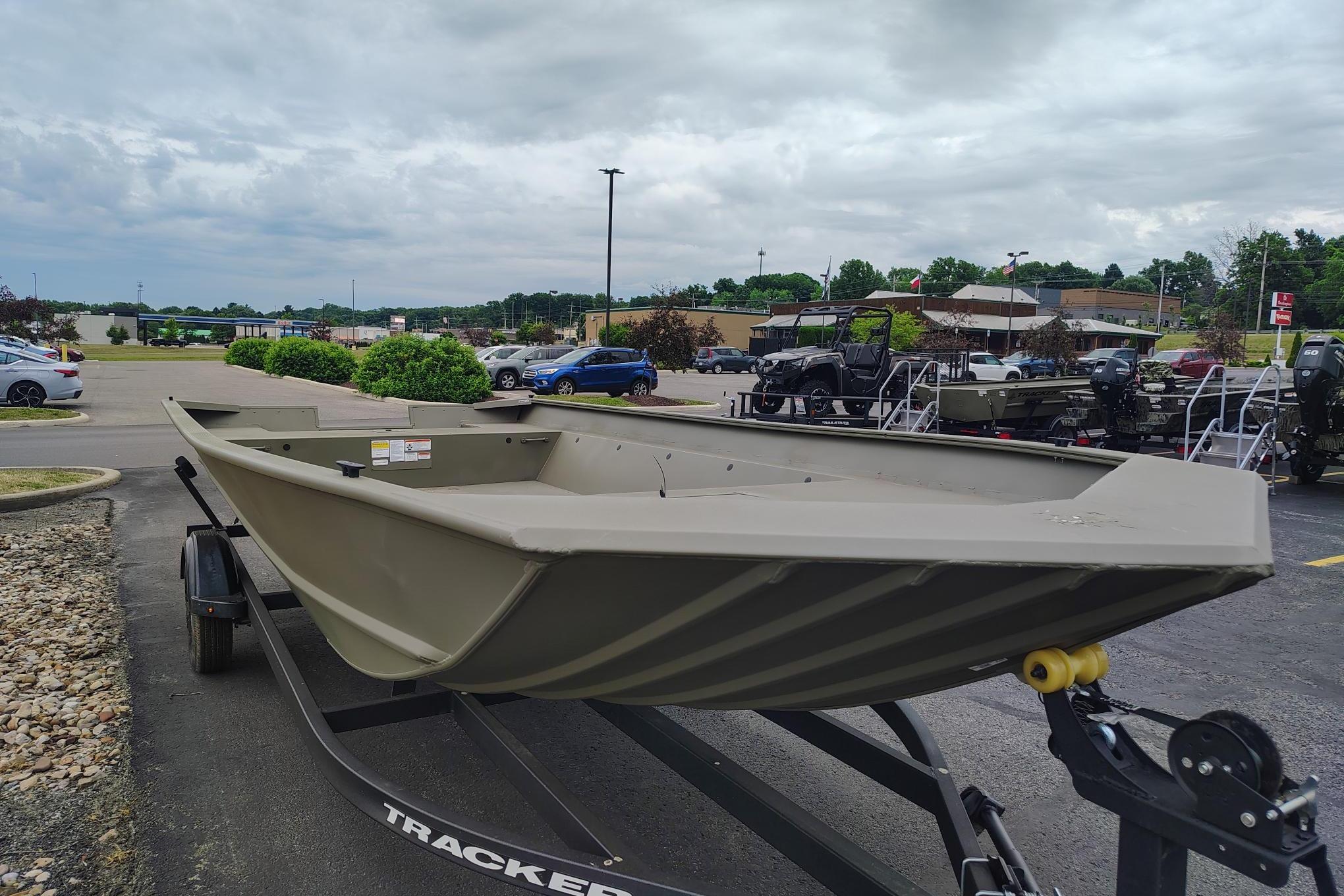 2026 Tracker Grizzly 2072 Utility boat on trailer in parking lot.
