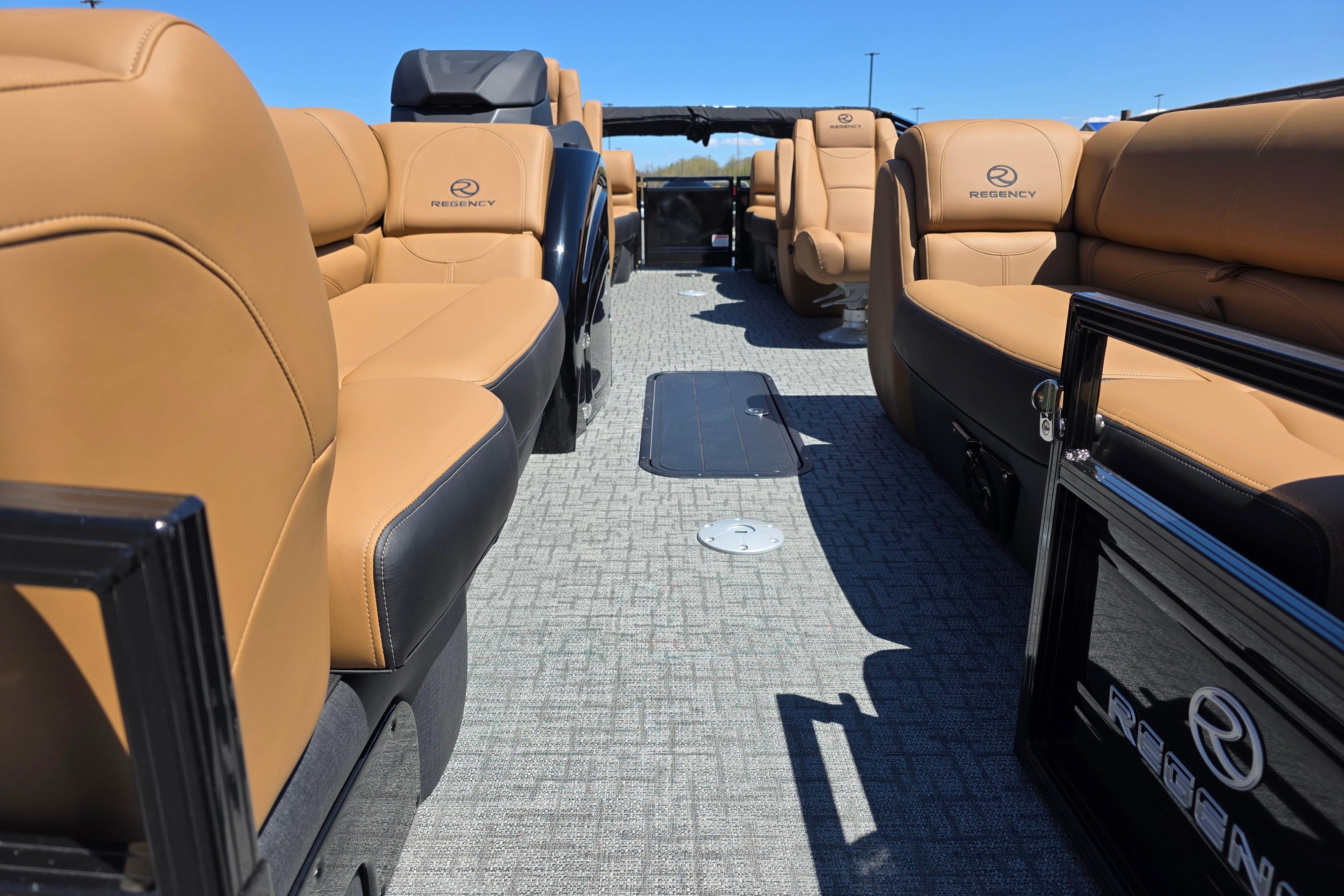 Luxurious interior of 2026 Regency 230 DL pontoon boat with tan seating and modern design.