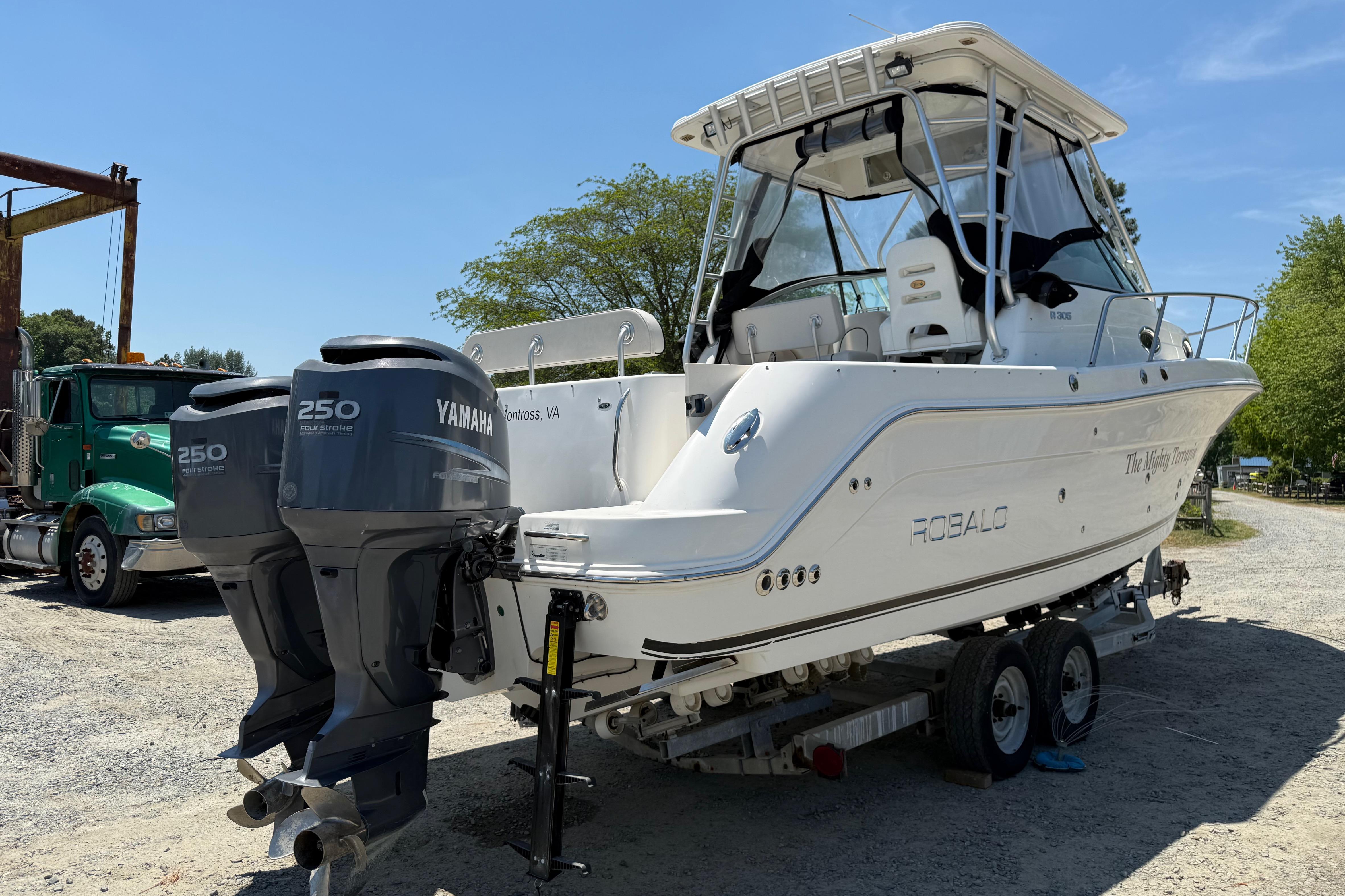 2007 Robalo R305 Walkaround boat with twin Yamaha 250 engines on a trailer.