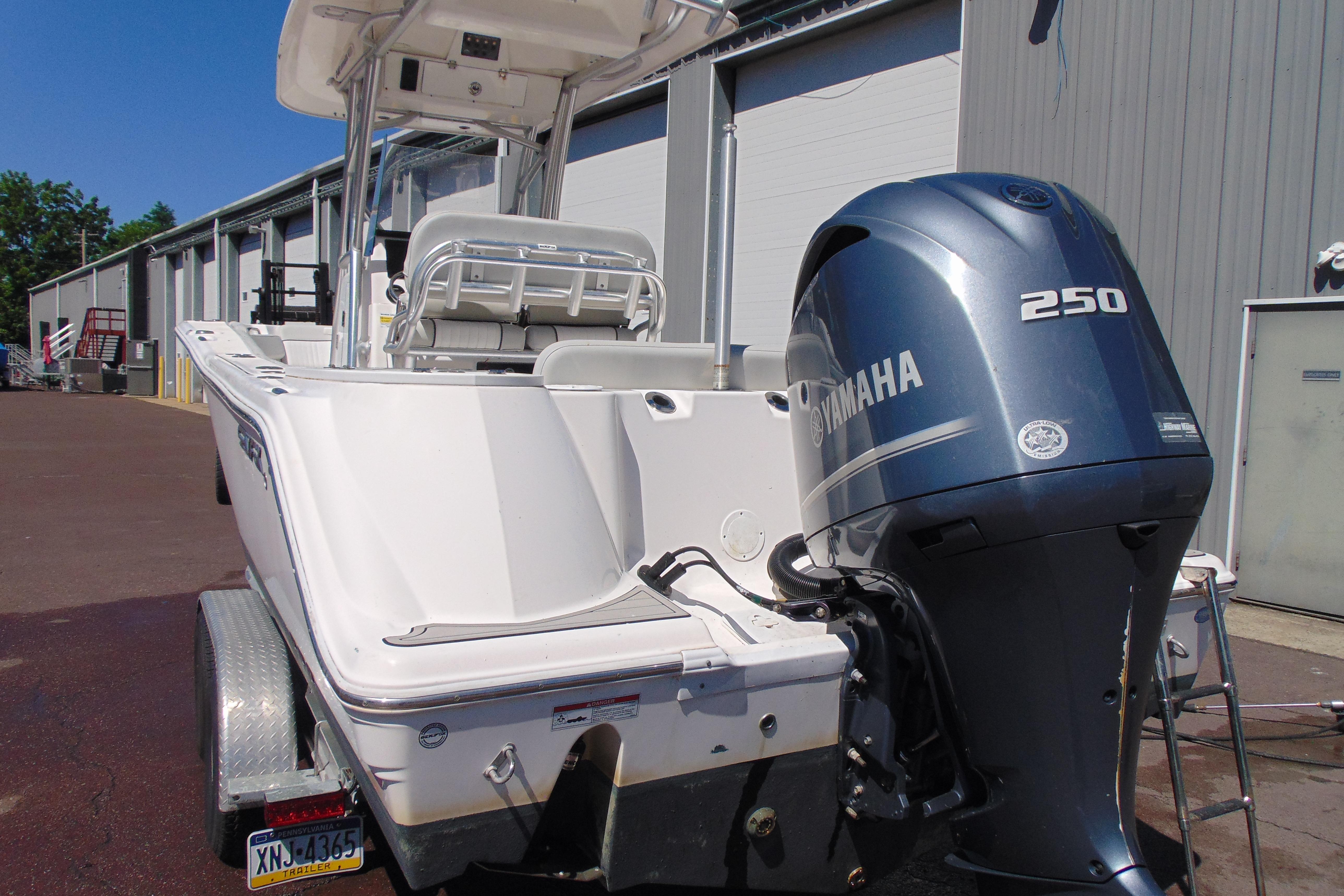 2022 Sea Fox 248 Commander boat with Yamaha 250 engine, parked outdoors.