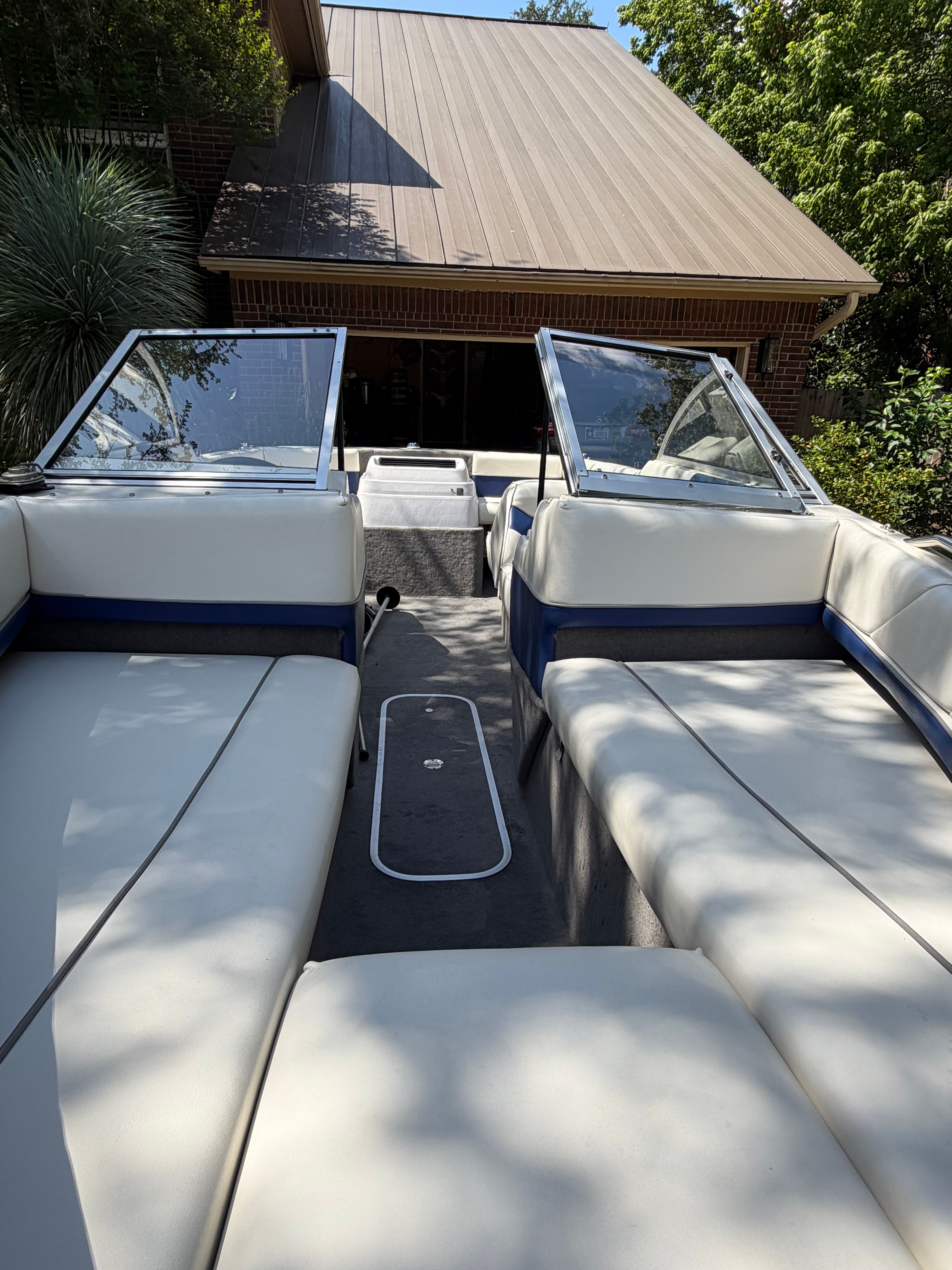 Interior view of a 1994 Bayliner CAPRI with white seats and blue accents.