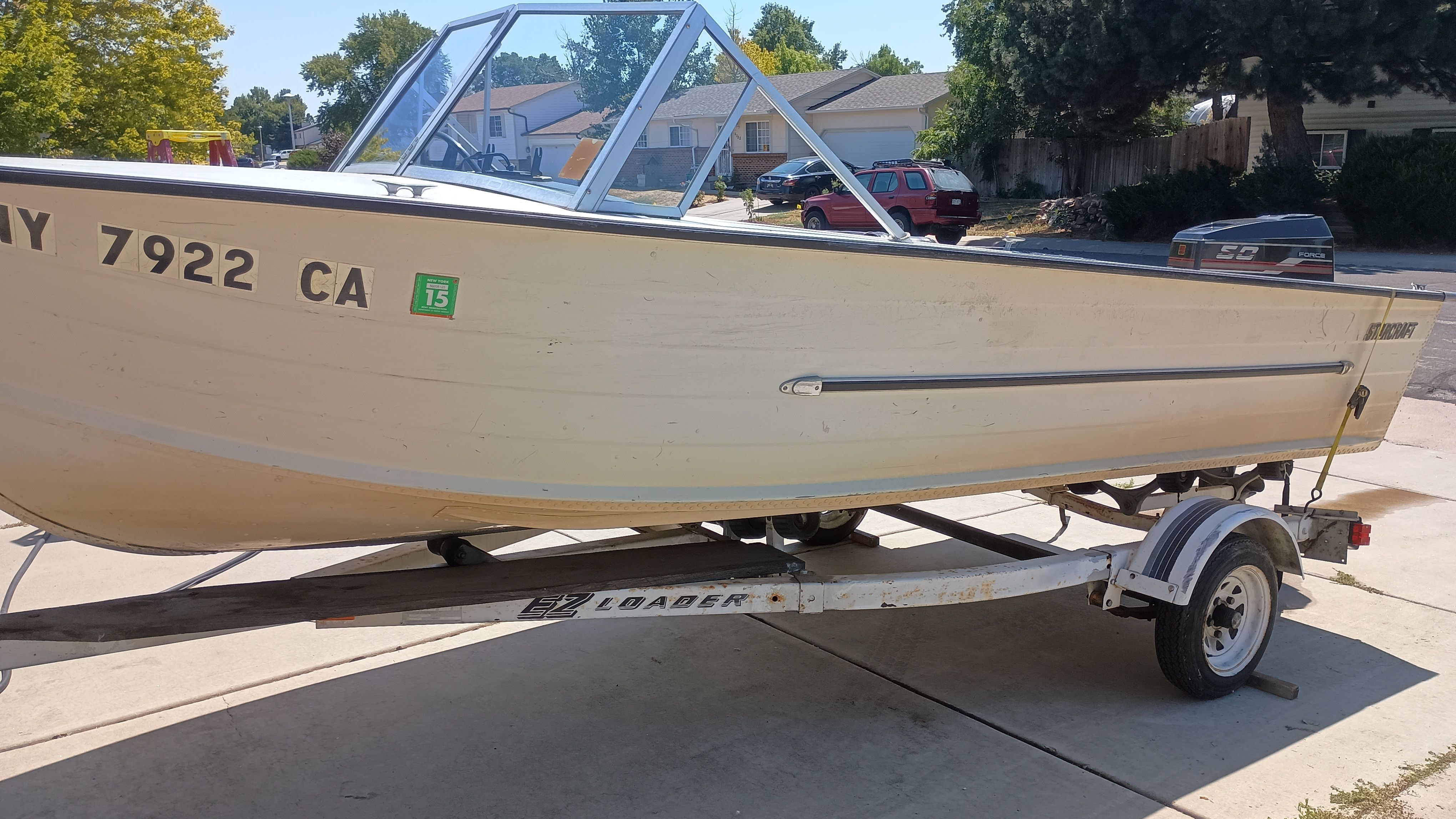 1970 Starcraft Jupiter V boat on trailer in residential area.