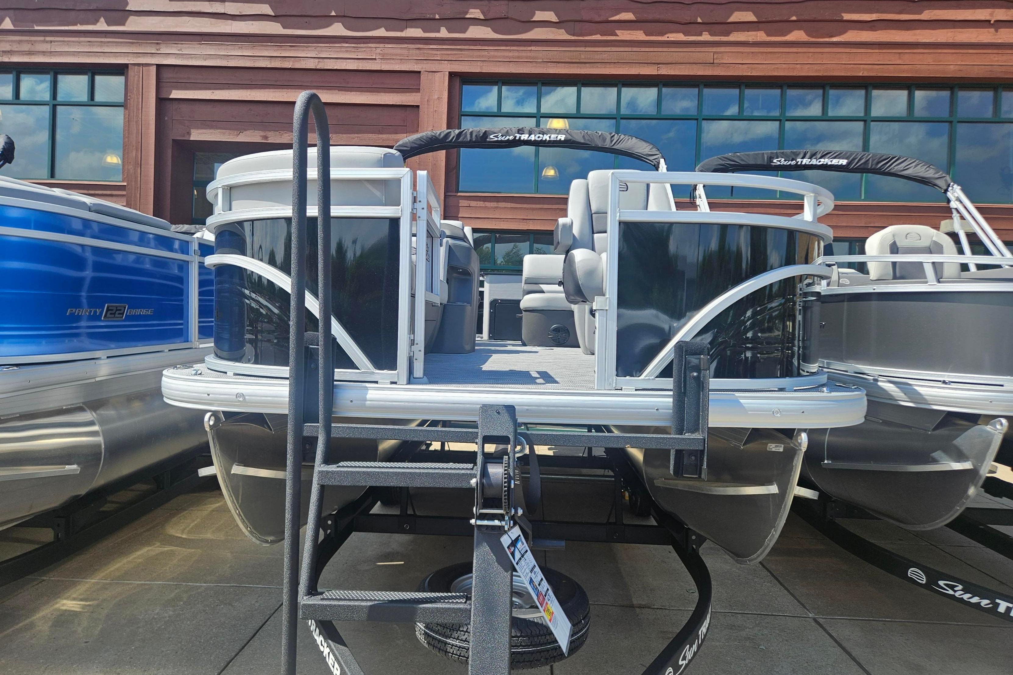2026 Sun Tracker SportFish 20 DLX pontoon boat displayed outdoors.
