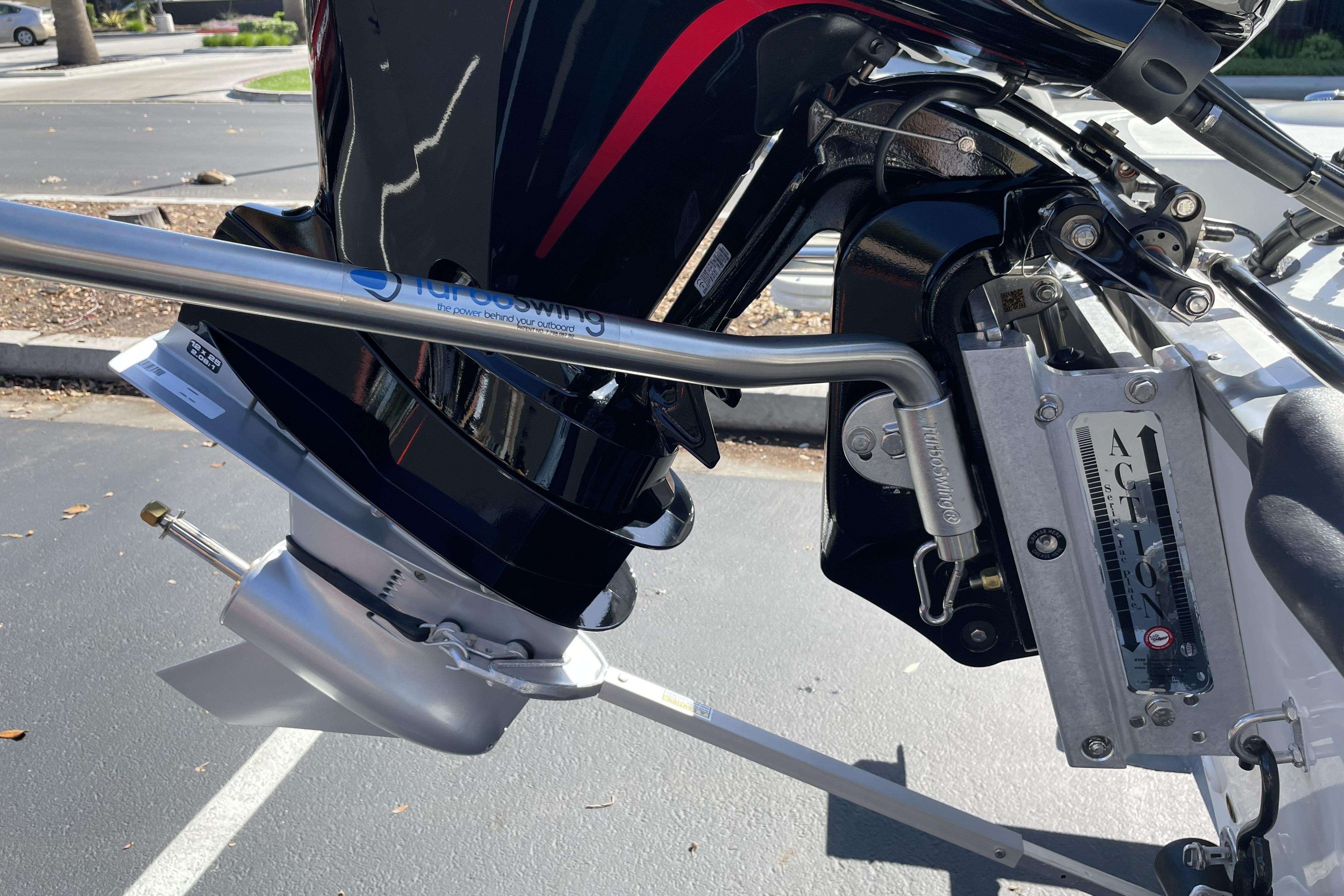 Outboard motor detail on 2026 Mako Pro Skiff 19 CC boat, featuring a stainless steel propeller.
