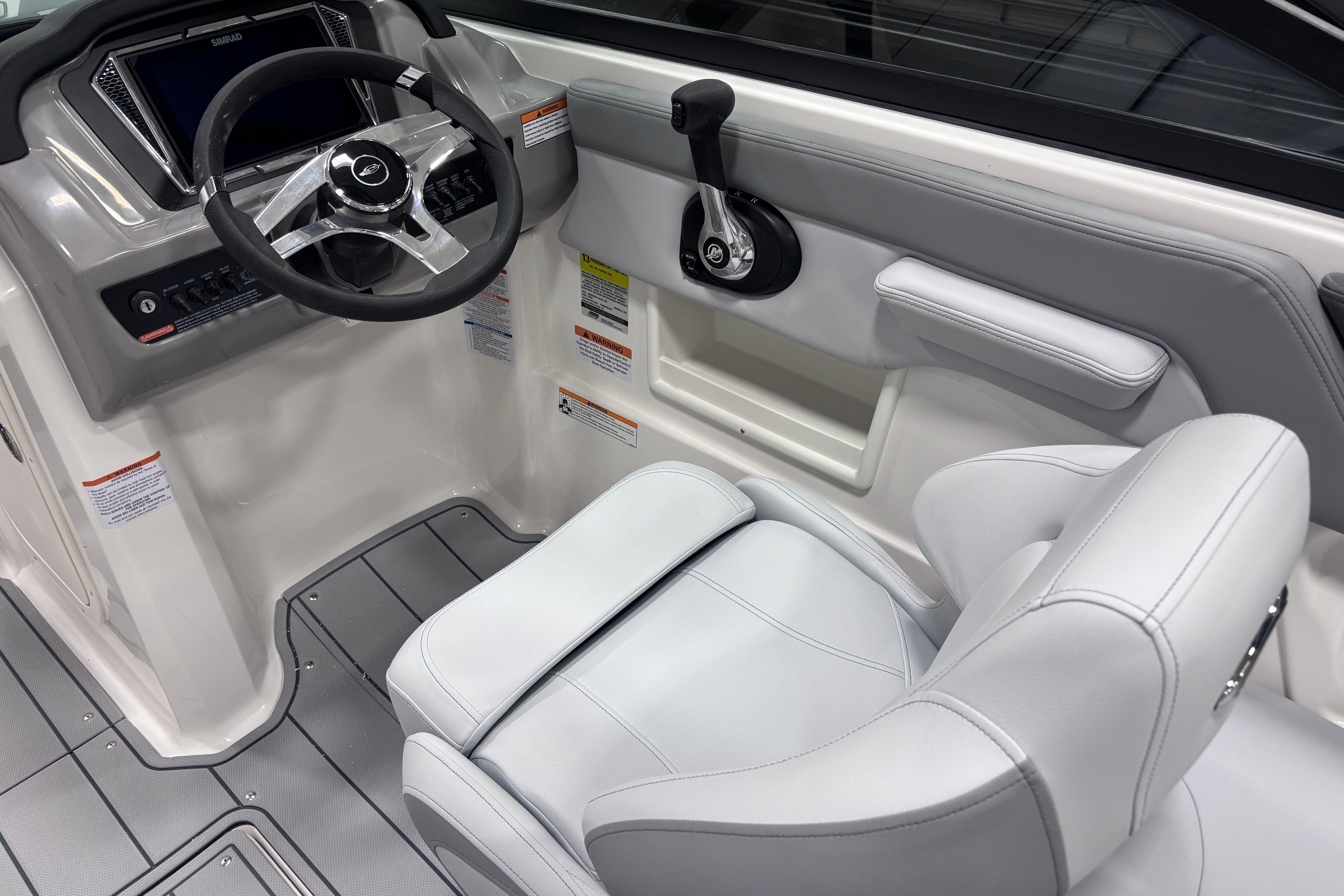 2026 Chaparral 23 SSi boat cockpit with steering wheel and control panel.
