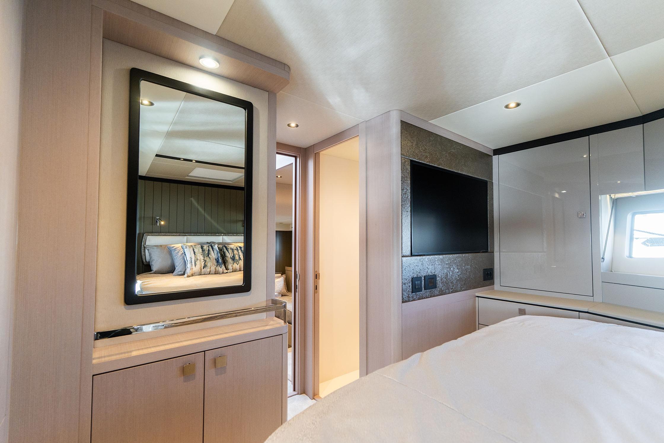 Luxurious interior of 2026 Sunseeker Manhattan 68 yacht bedroom with modern decor.