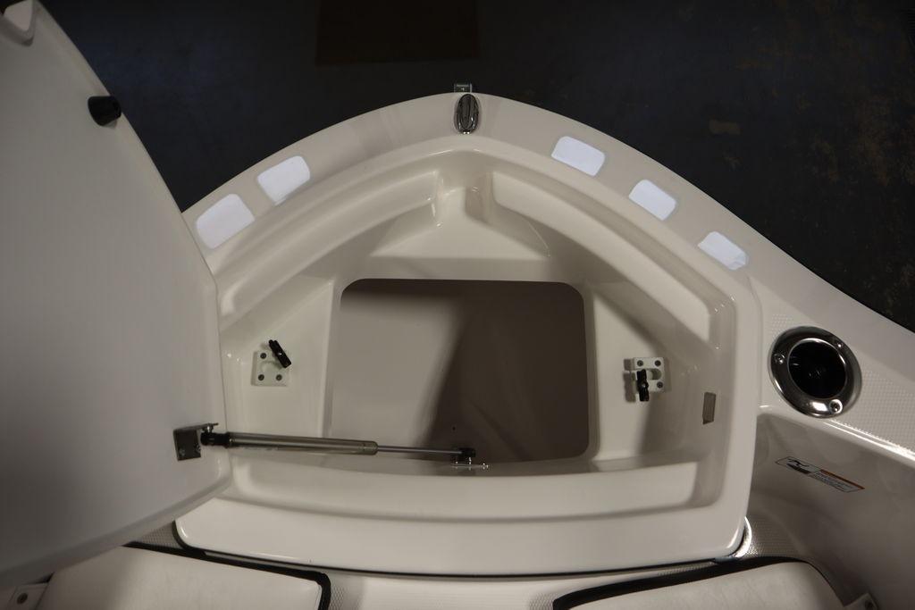 2026 Yamaha Boats 255 FSH Sport E storage compartment, open lid, interior view.