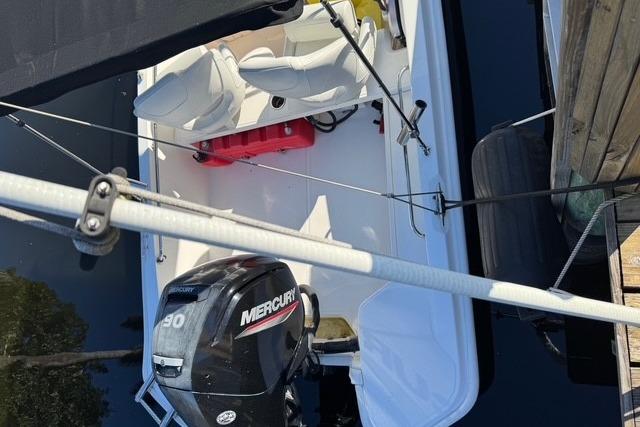 2024 Boston Whaler 160 SS boat with Mercury engine, docked, aerial view.