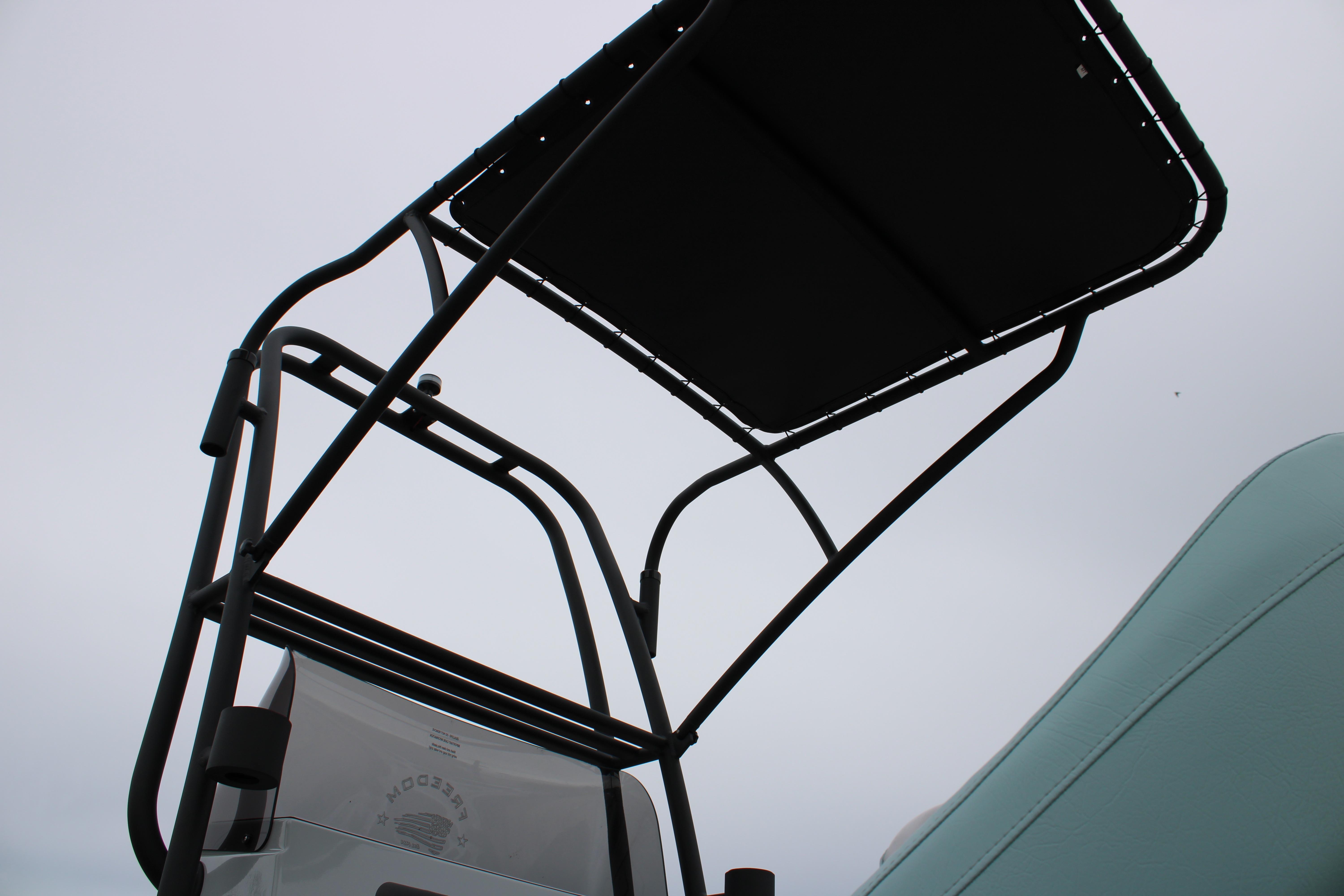 2026 Freedom Boats 24 Defender, T-top view against cloudy sky.