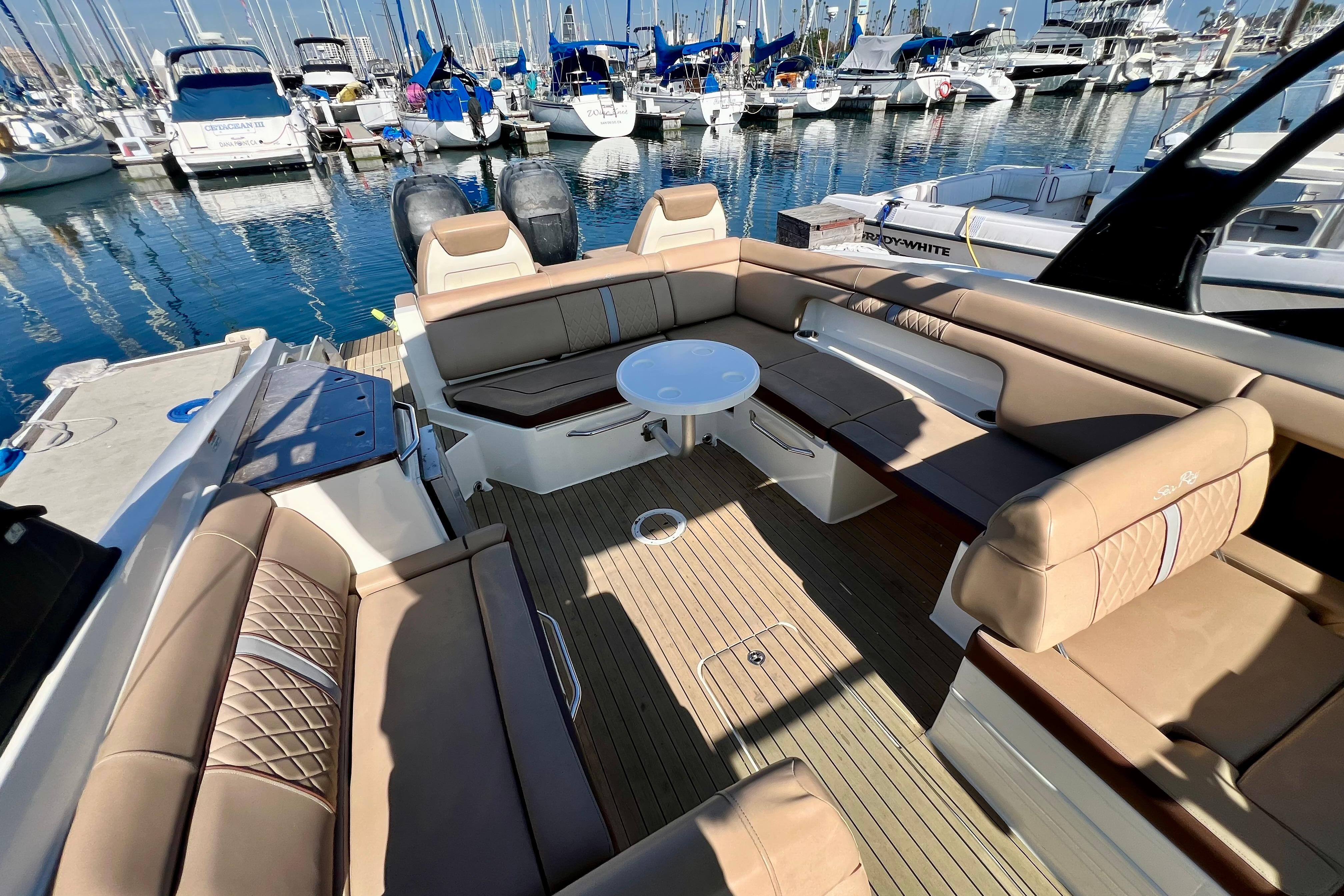 2016 Sea Ray 290 Sundeck Outboard with spacious seating at a marina.
