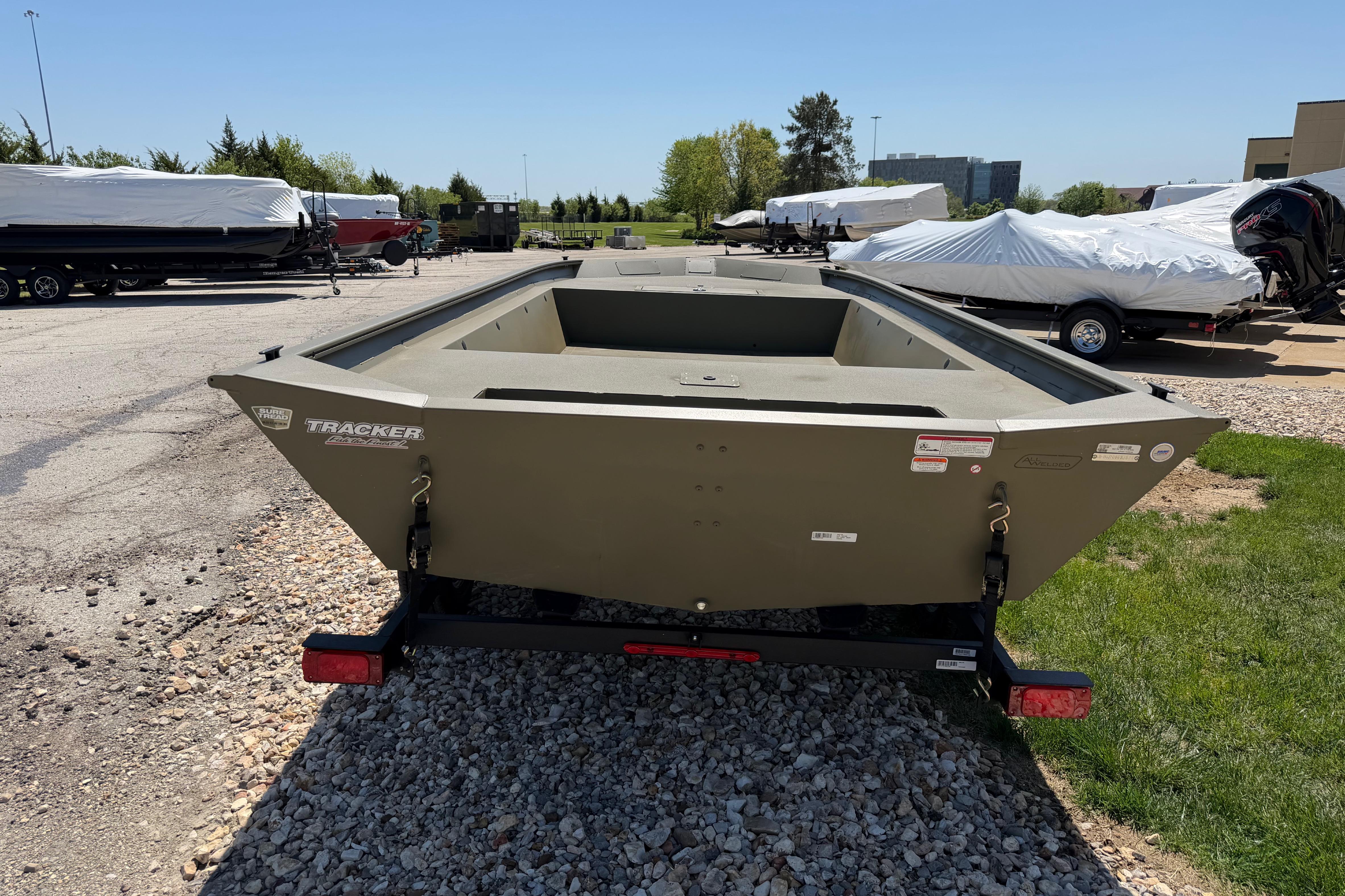 2026 Tracker Grizzly 1860 Utility boat on trailer in outdoor lot.