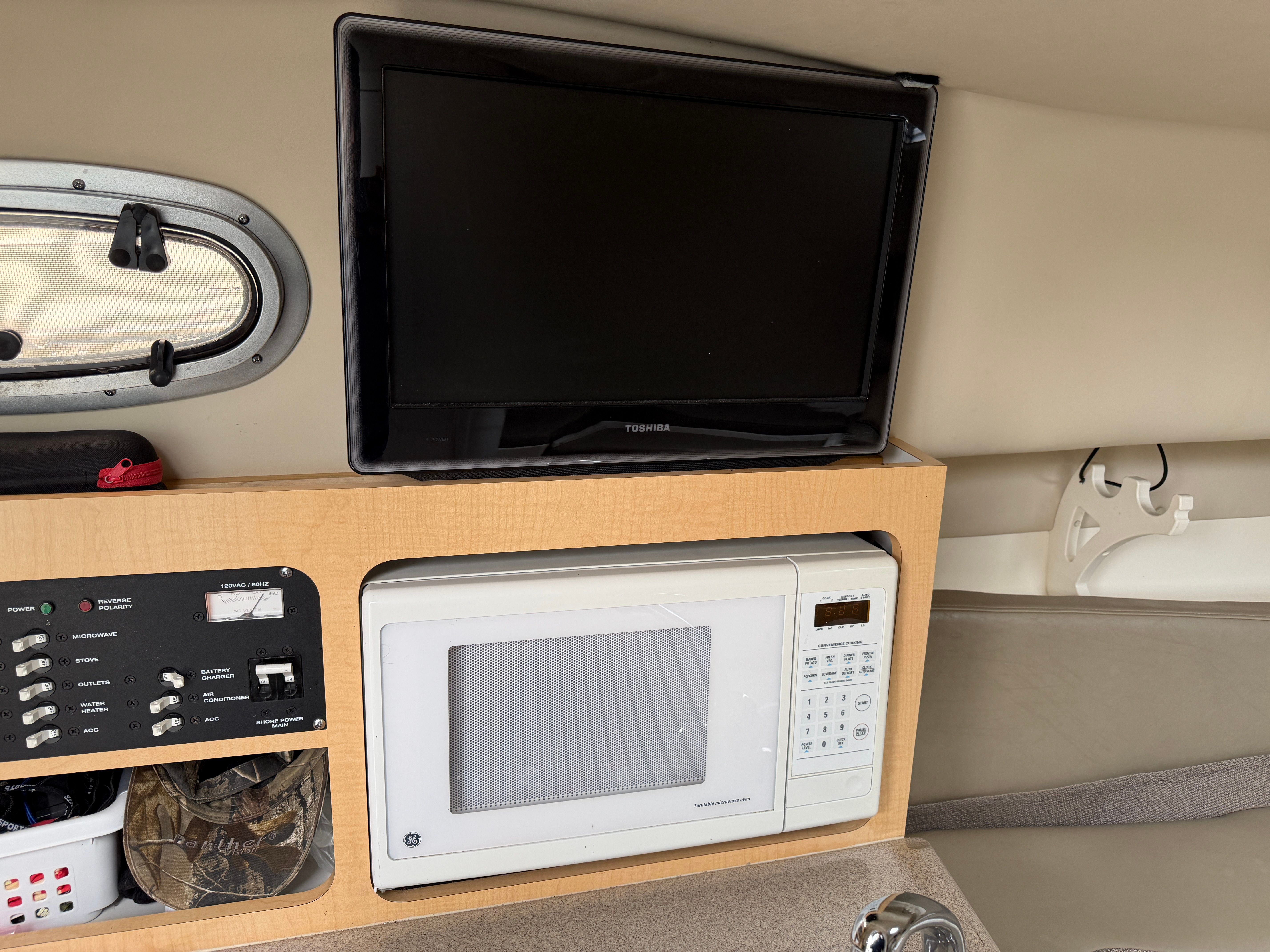 Interior of a Boston Whaler 26 Conquest with a microwave and TV.