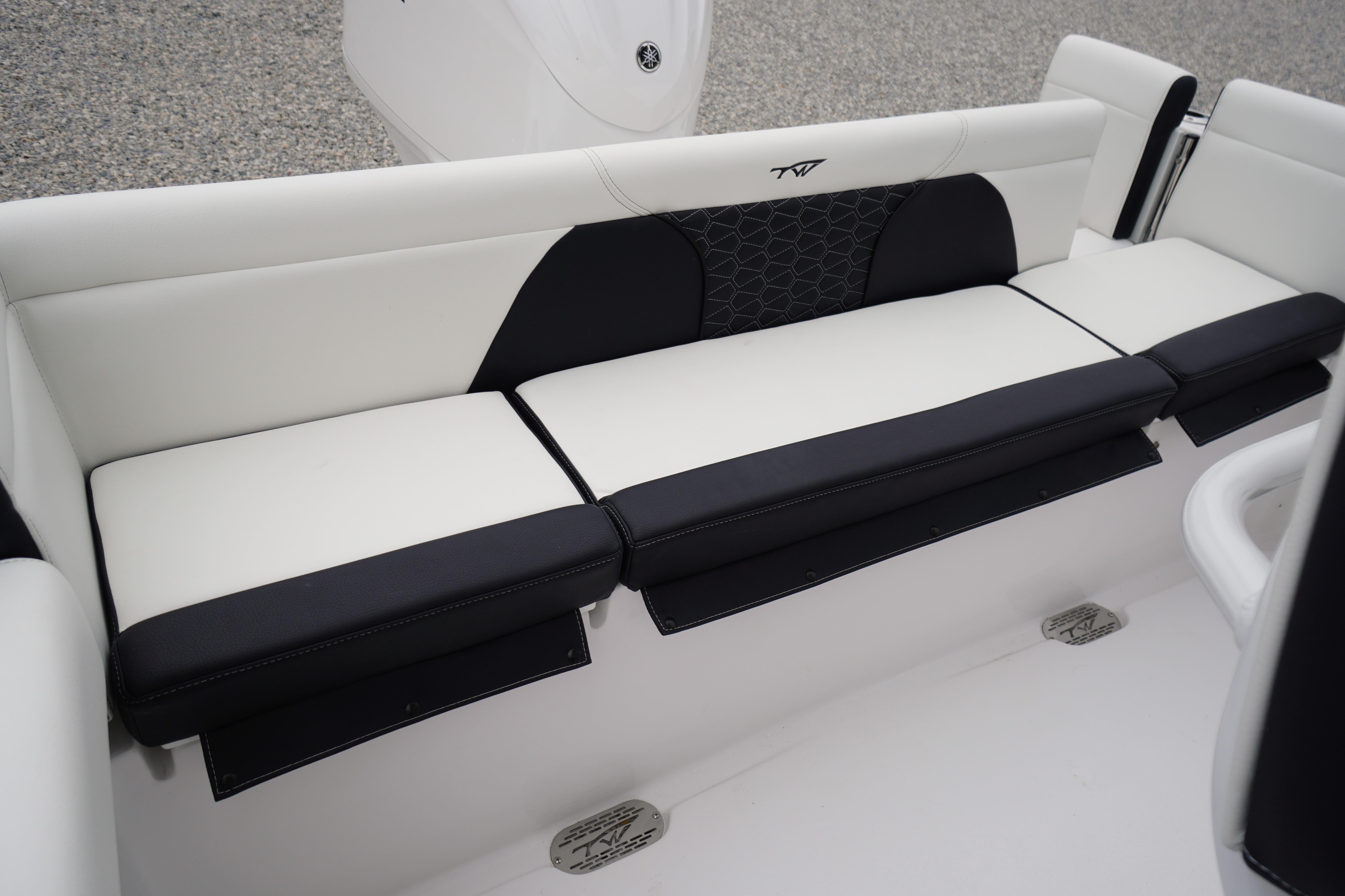 2026 Tidewater 232 SS boat interior seating, featuring sleek black and white upholstery.