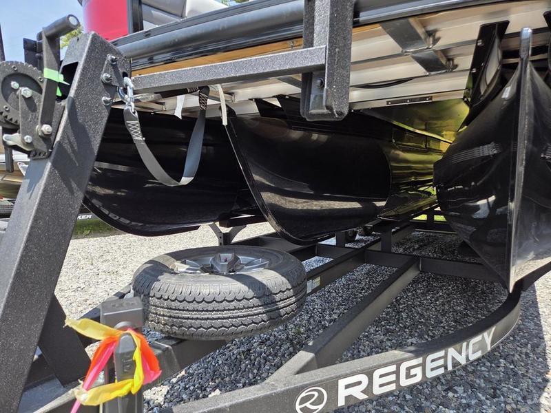 2025 Regency 230 DL3 pontoon boat on trailer, showing undercarriage and spare tire.