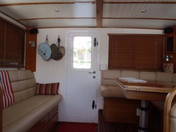 Interior of 2025 Great Harbour N40 yacht with beige seating and wooden accents.