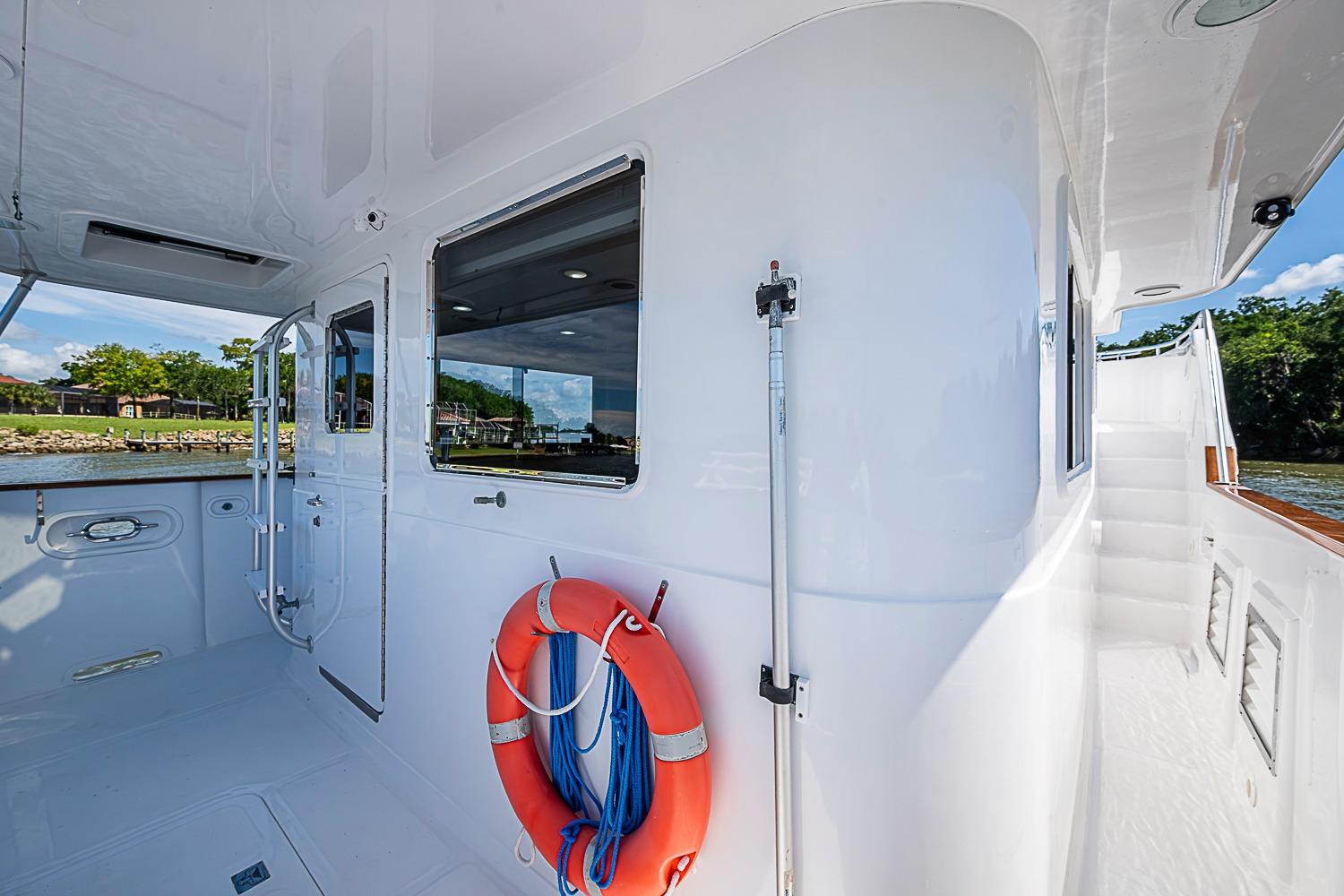 2003 Magna Marine Nova Scotia 47 yacht deck with life preserver and scenic view.