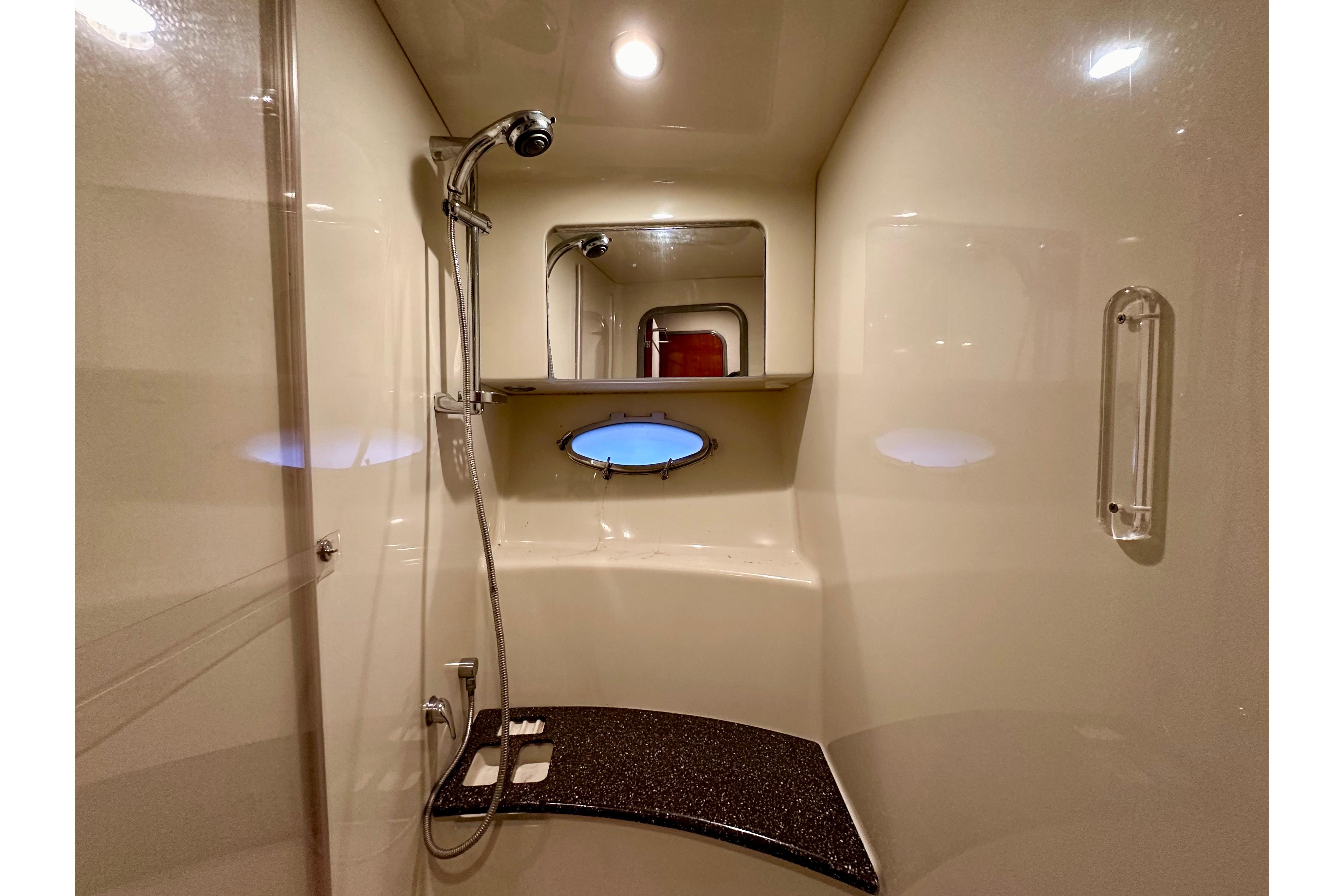 Luxurious bathroom in 2008 Formula 45 Yacht with shower and porthole window.