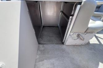2012 Avalon Tahoe boat interior storage compartment with open hatch and seating.