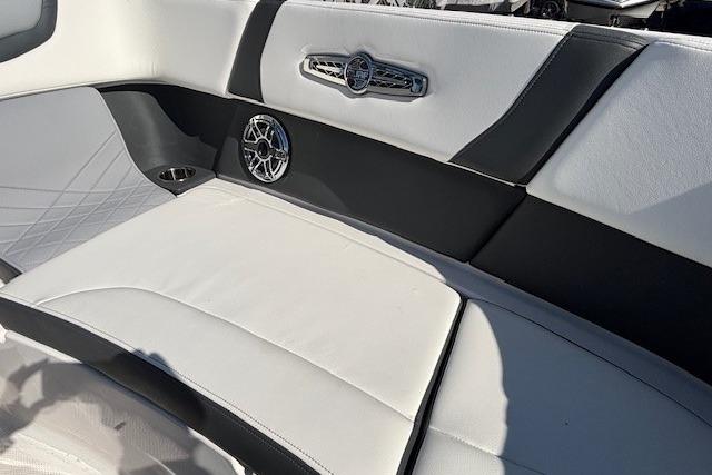 2024 Chaparral 30 Surf boat interior with stylish seating and speaker detail.