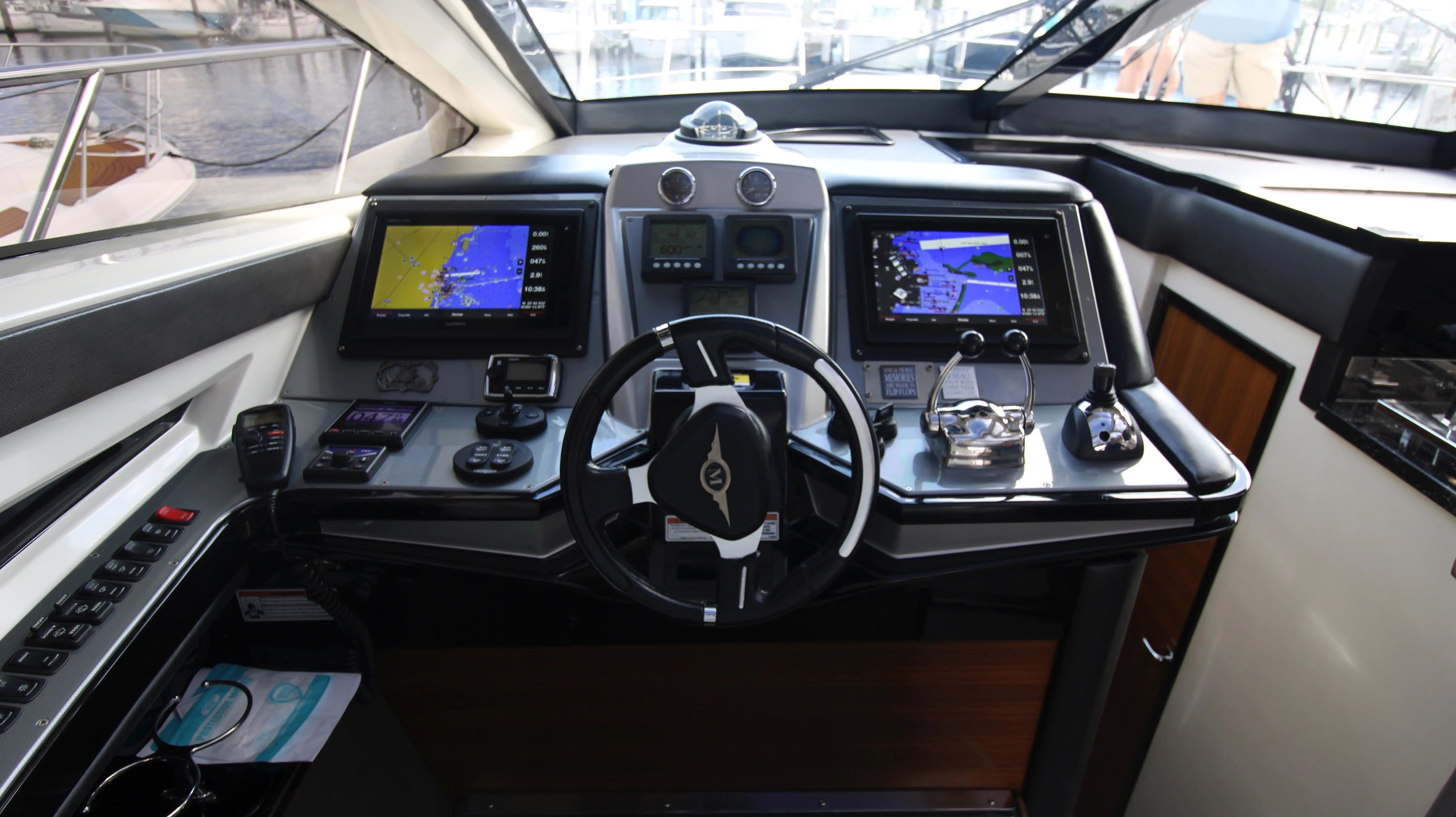 The cockpit of a 2010 Marquis Sport Coupe with modern navigation systems and controls.