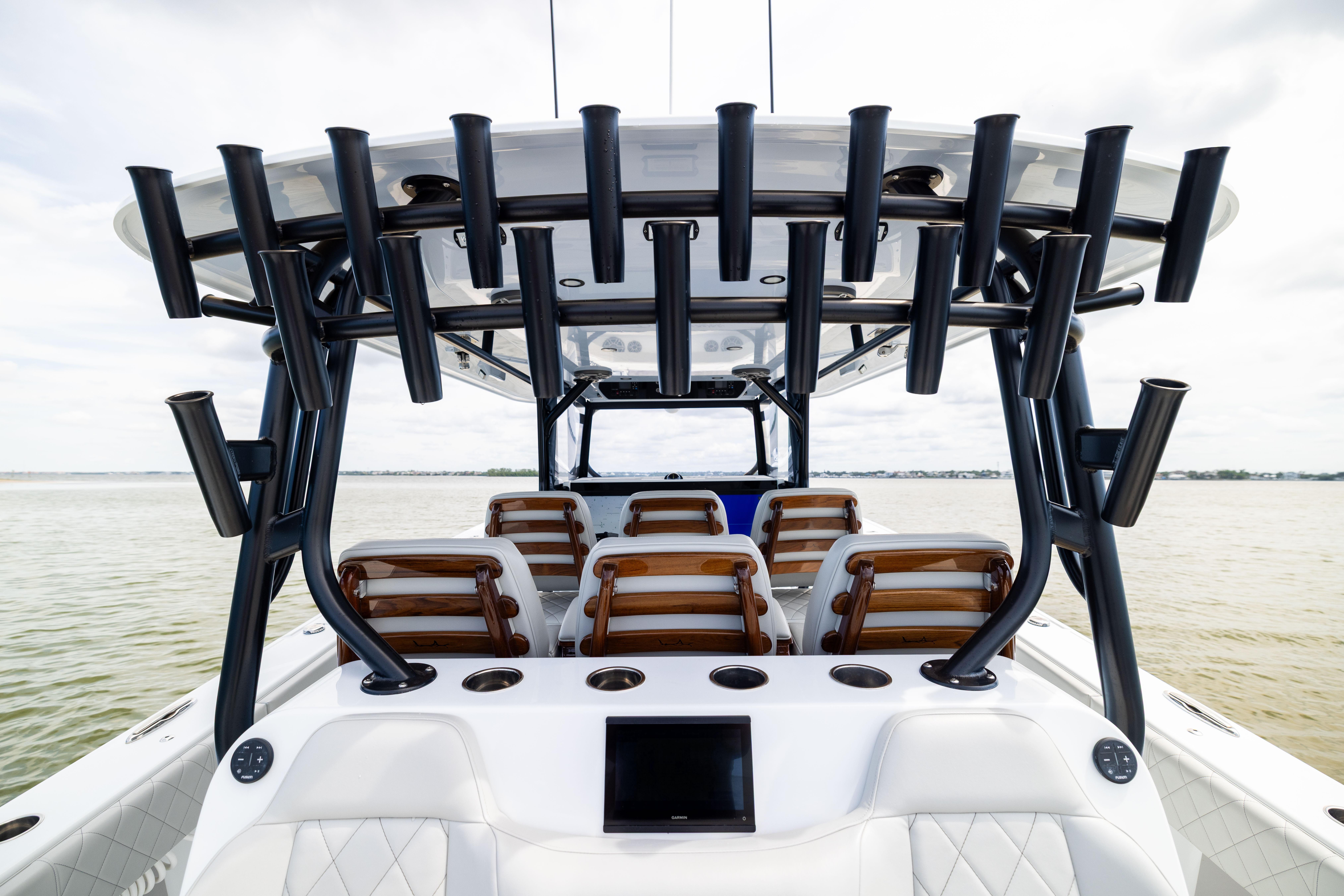 2025 Freeman 42 LR boat interior with rod holders and seating on calm water.