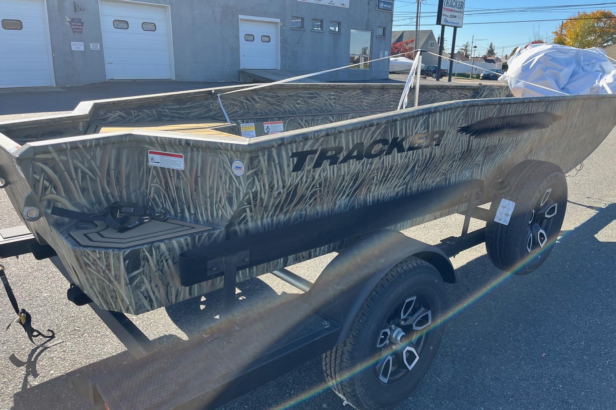 2026 Tracker Grizzly 1650 T Prairie Wings Edition boat on trailer, camo design.