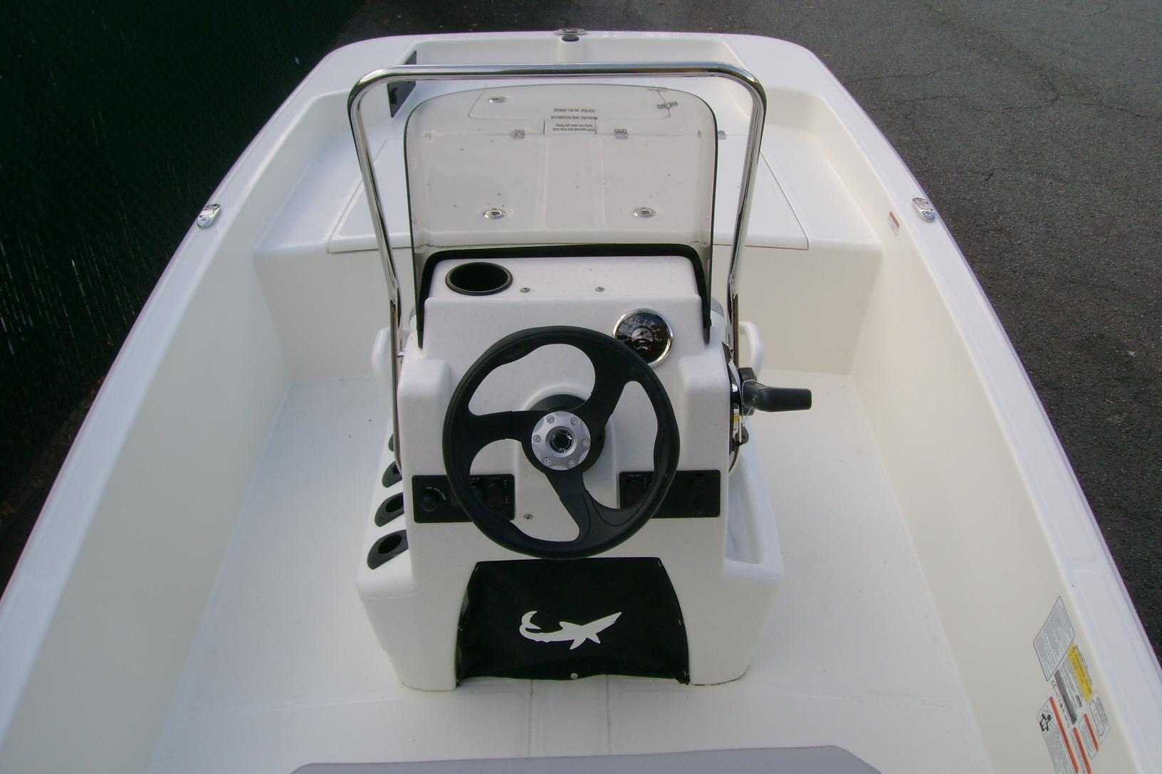 2026 Mako Pro Skiff 15 CC boat interior with steering wheel and console.