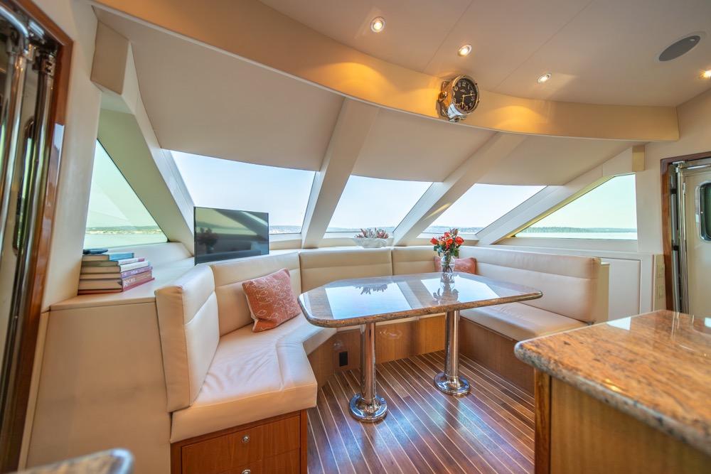 Luxurious interior of 2008 Hatteras 72 Motor Yacht with elegant seating and panoramic windows.