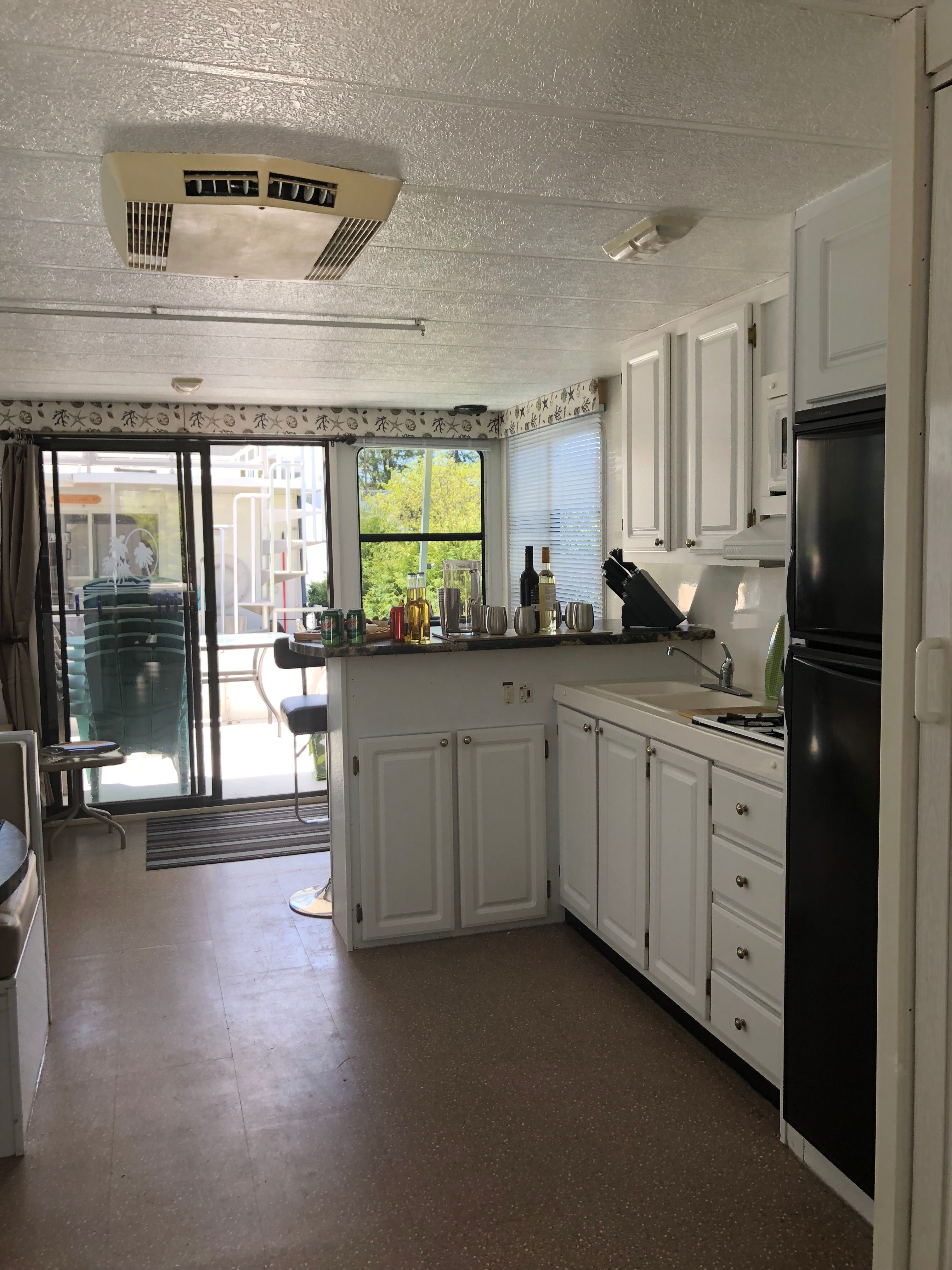 Interior of a 2004 42 ft Catamaran Cruiser featuring a kitchen and living area.