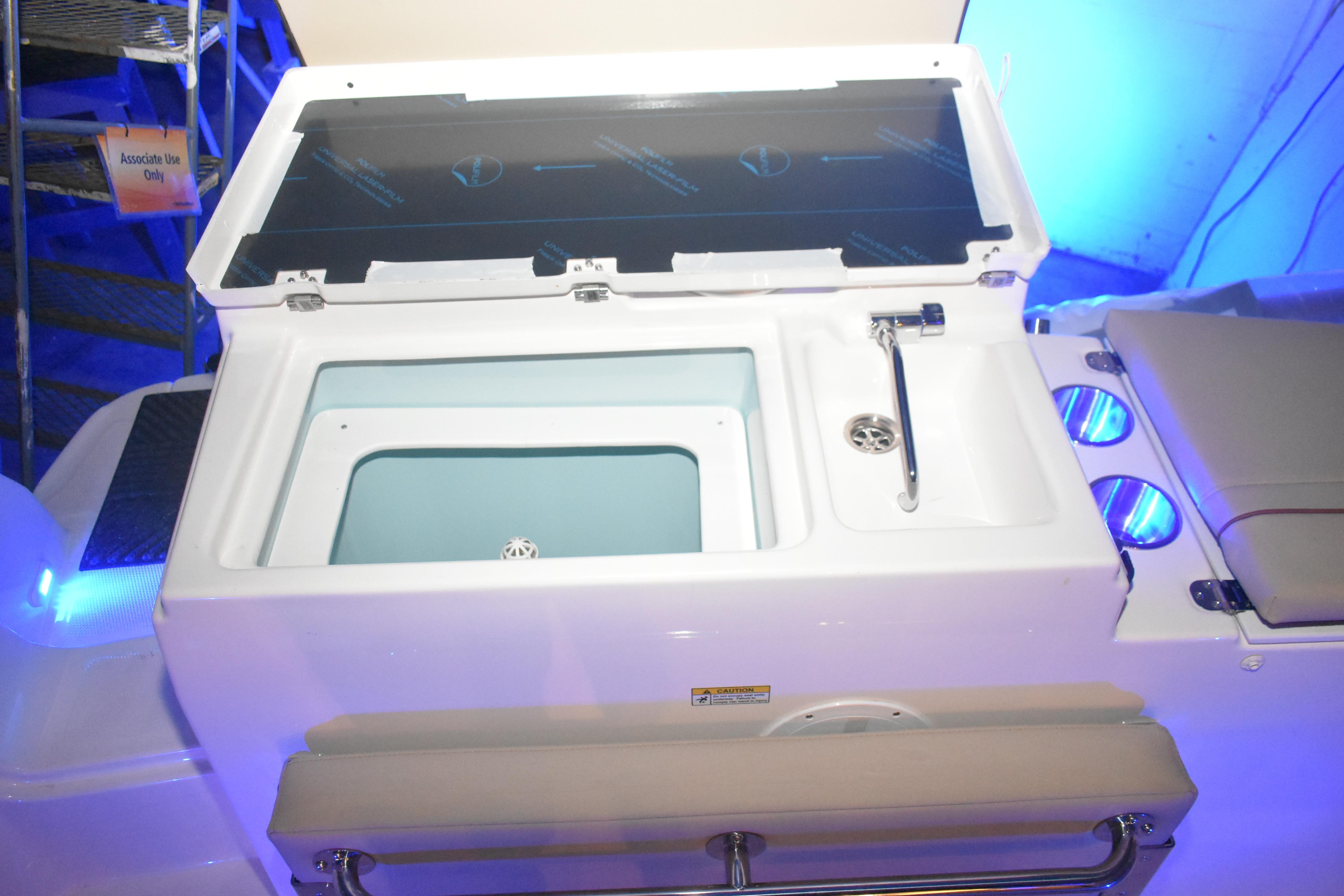 2026 Cutwater C-248 Coupe boat interior with open storage compartment and sink.