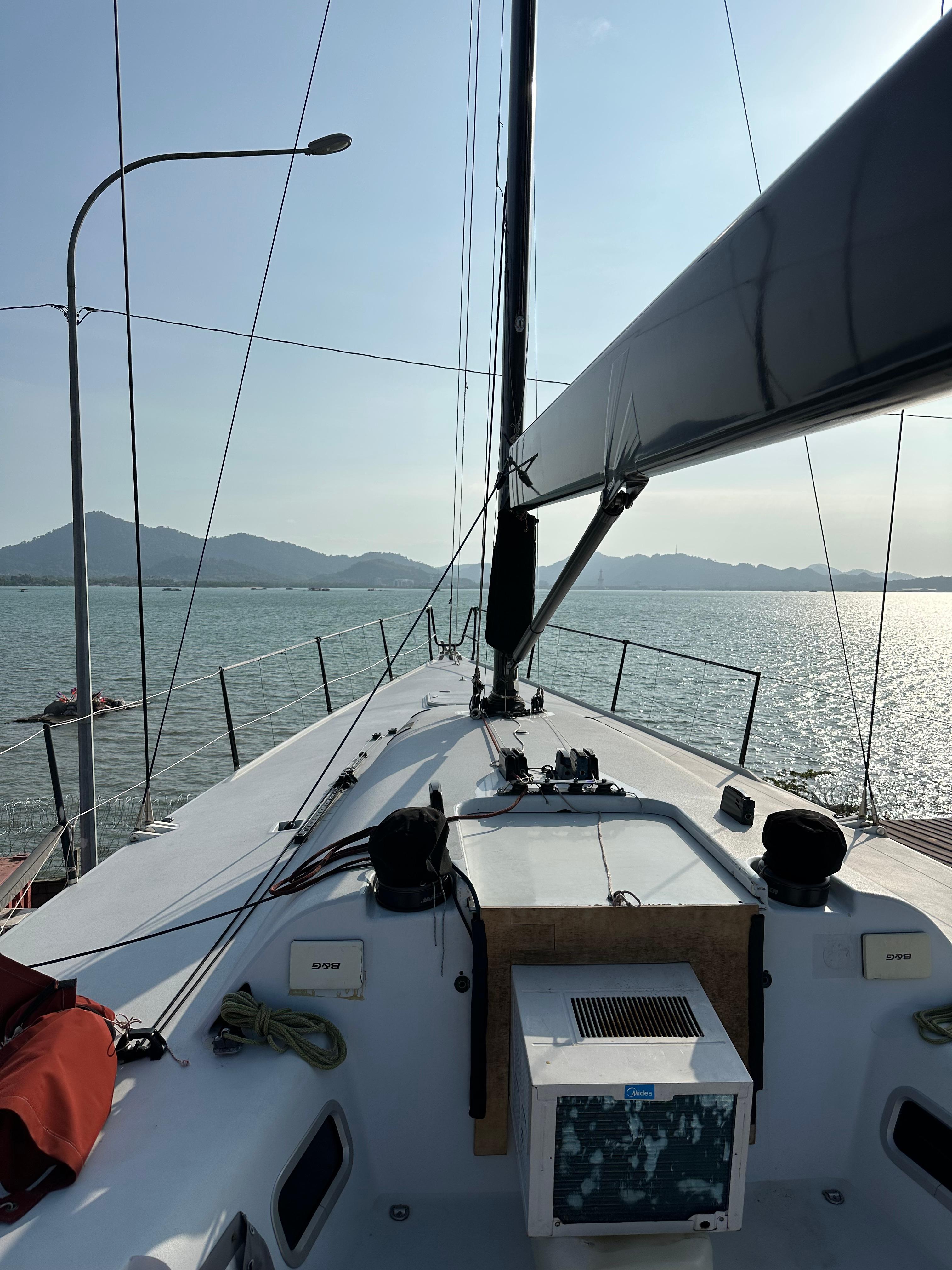 Sailing on 2007 Custom Welbourn IRC/ORC 52 yacht, serene waters, distant mountains.