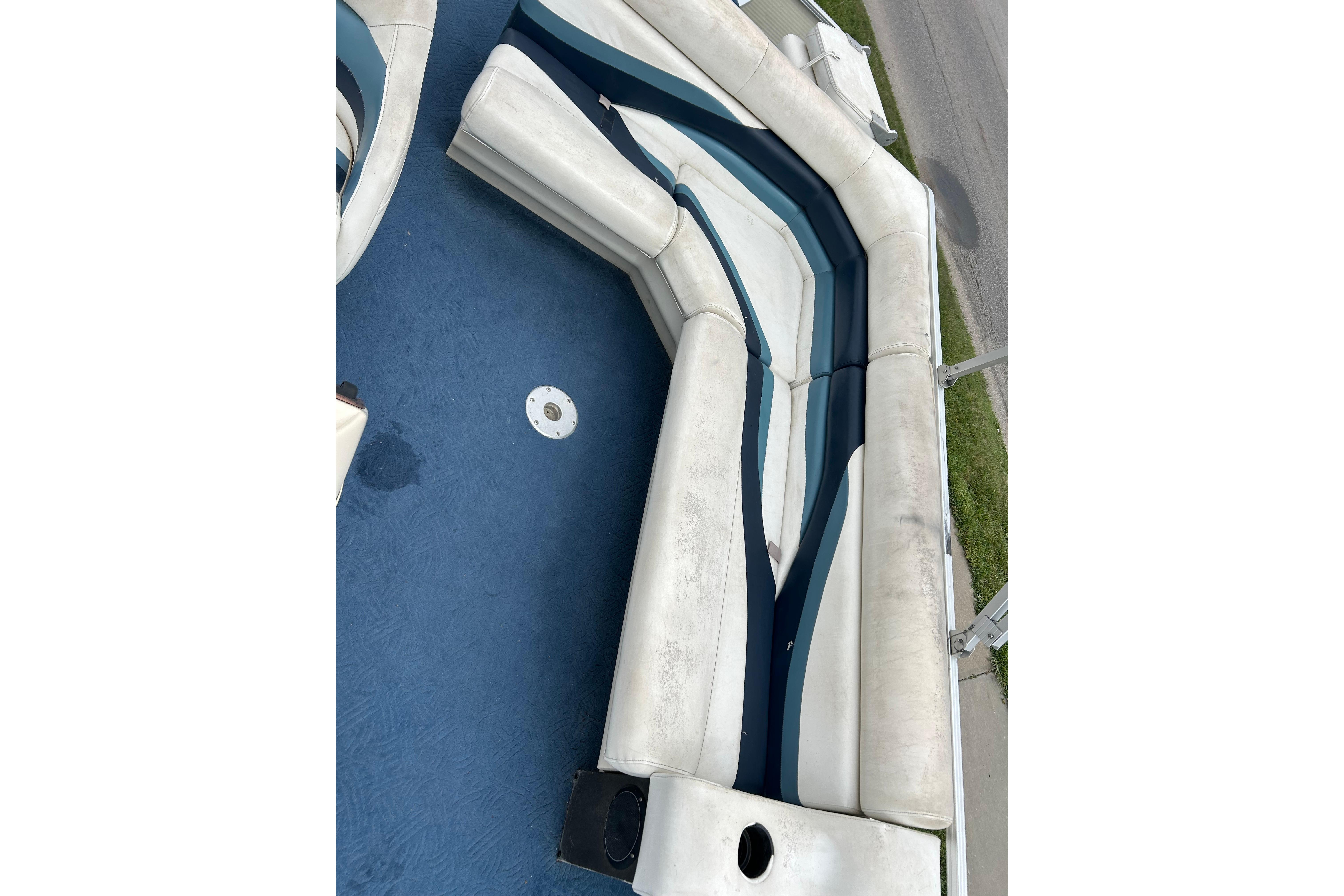 White and blue seating on a 2002 Lowe Trinidad 200 boat deck.