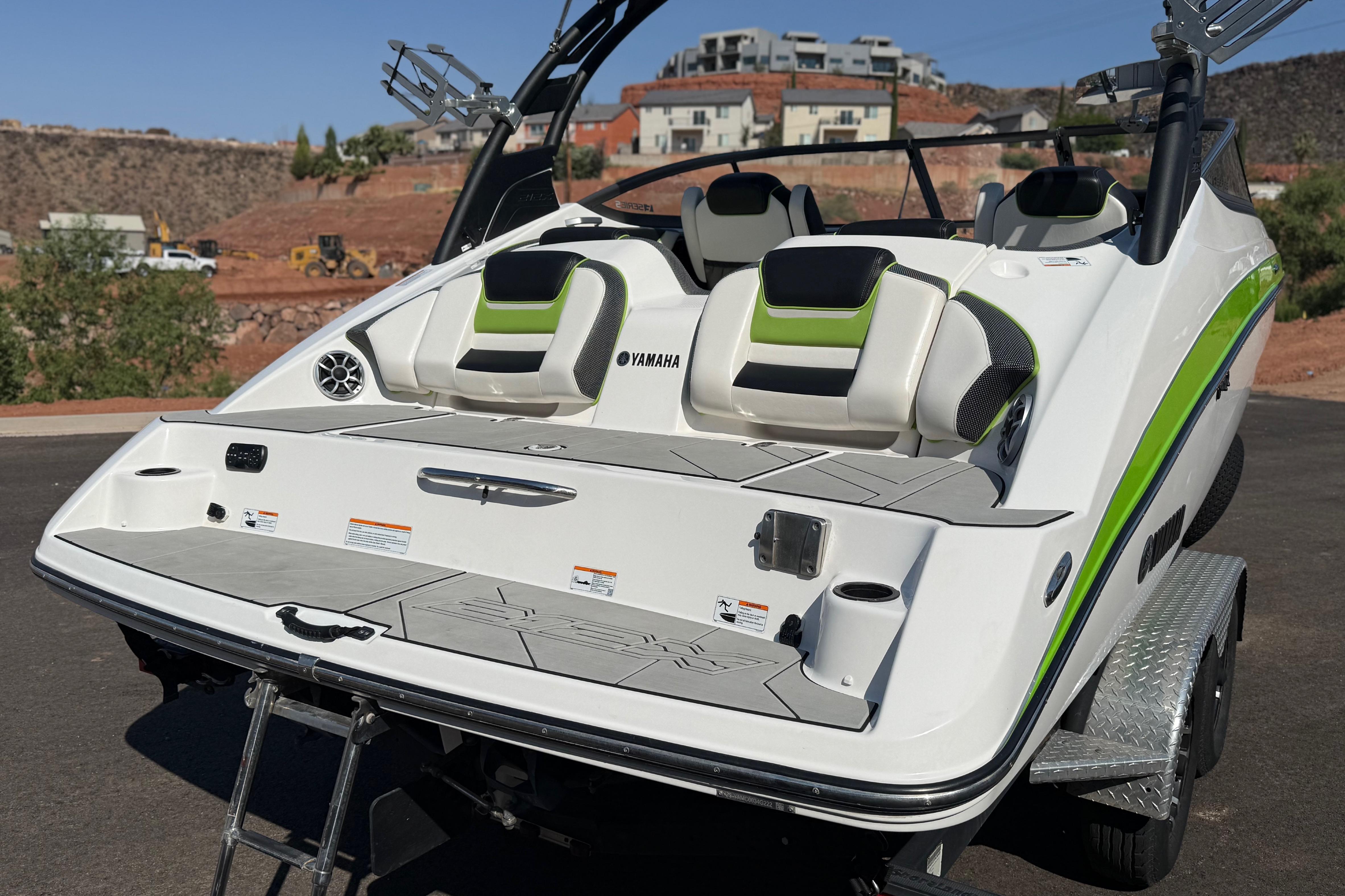 2022 Yamaha Boats 212XE with sleek design and comfortable seating, parked on a trailer.