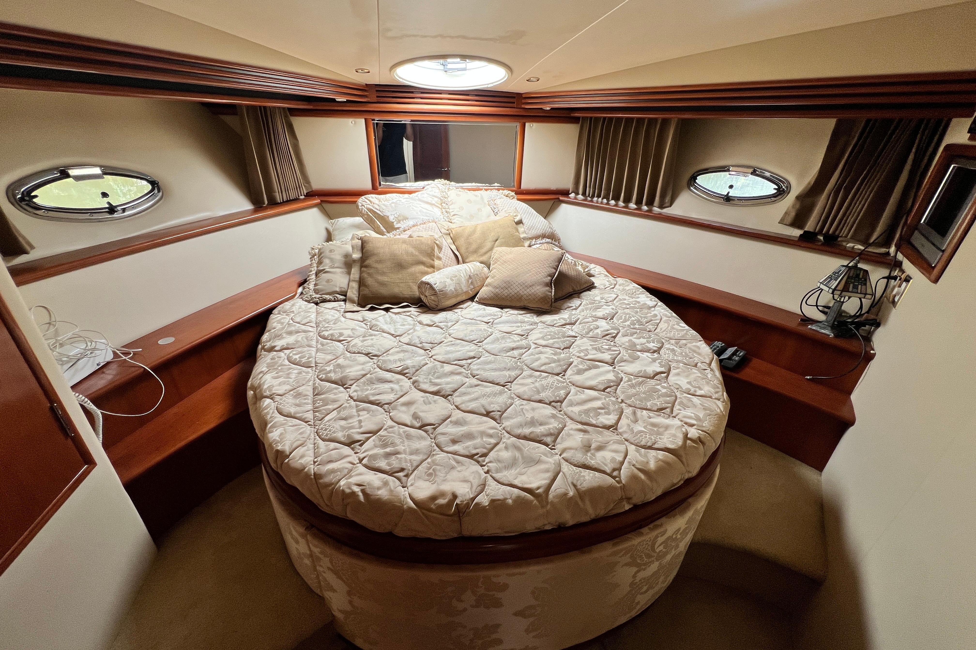 Luxurious bedroom interior of 2003 Carver 450 Voyager Pilothouse yacht with round bed.