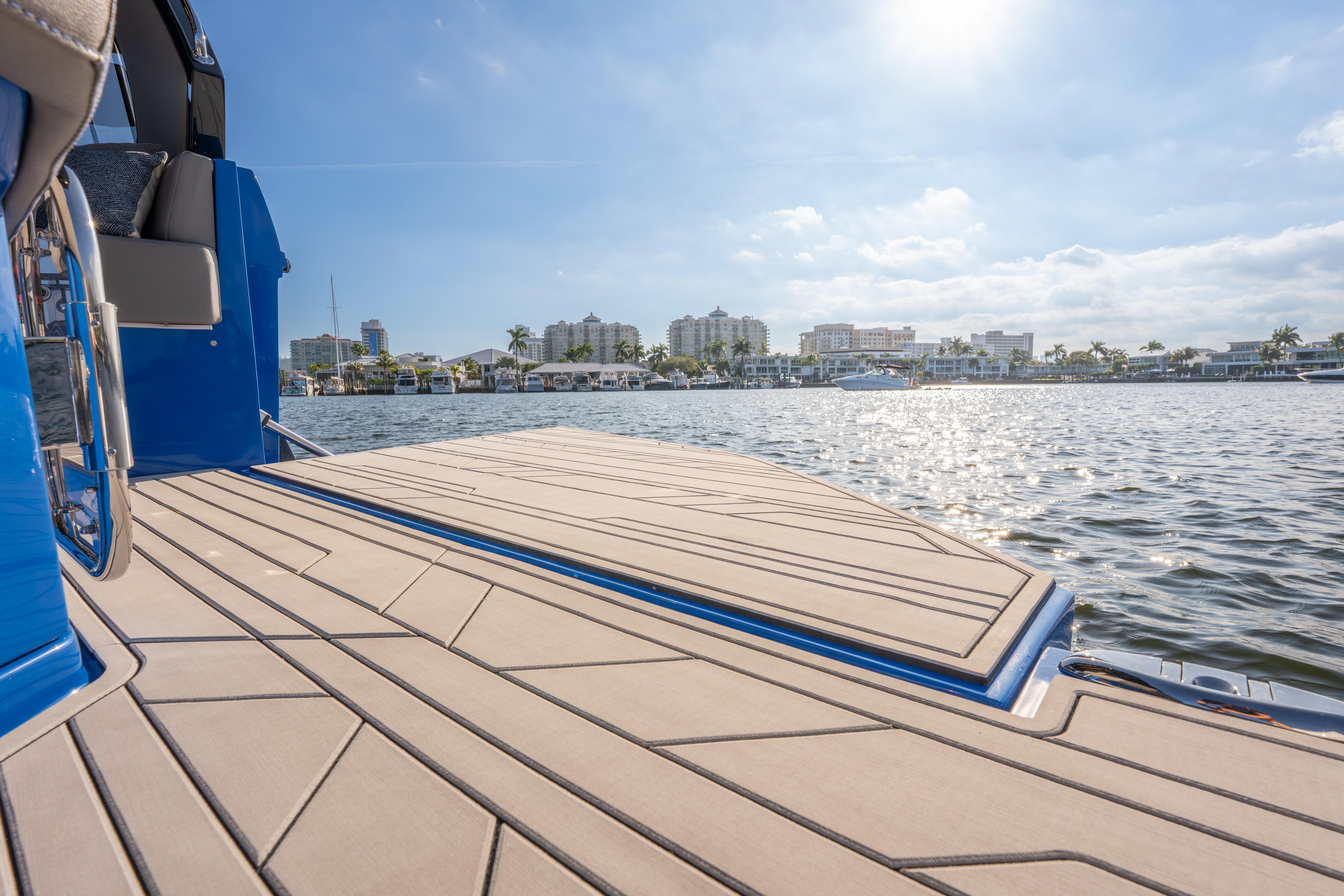 Luxury Hanover 347 boat deck overlooking sunny waterfront cityscape, 2026 model.