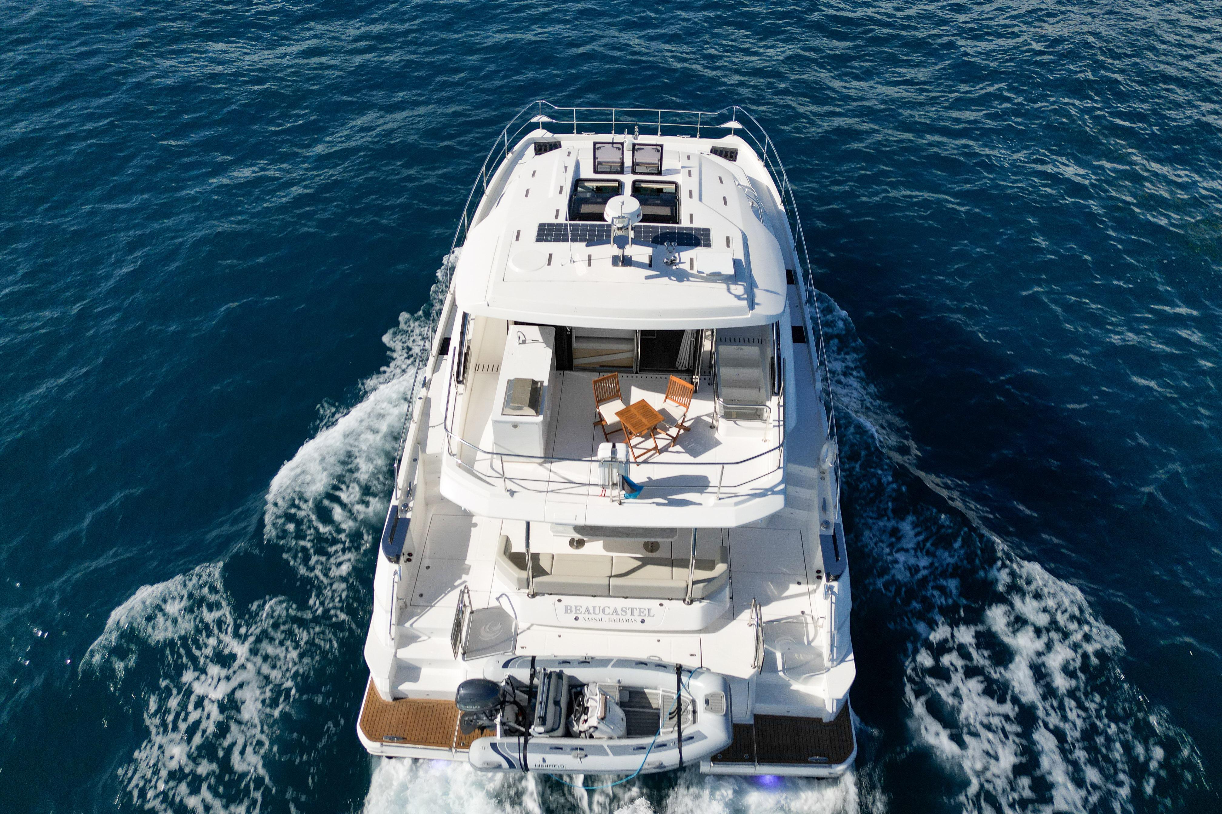 Aquila 54 Yacht 2025 cruising on open sea, aerial view.