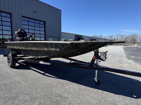 2025 SeaArk 1752 Slayer Pro boat on trailer, parked outside industrial building.