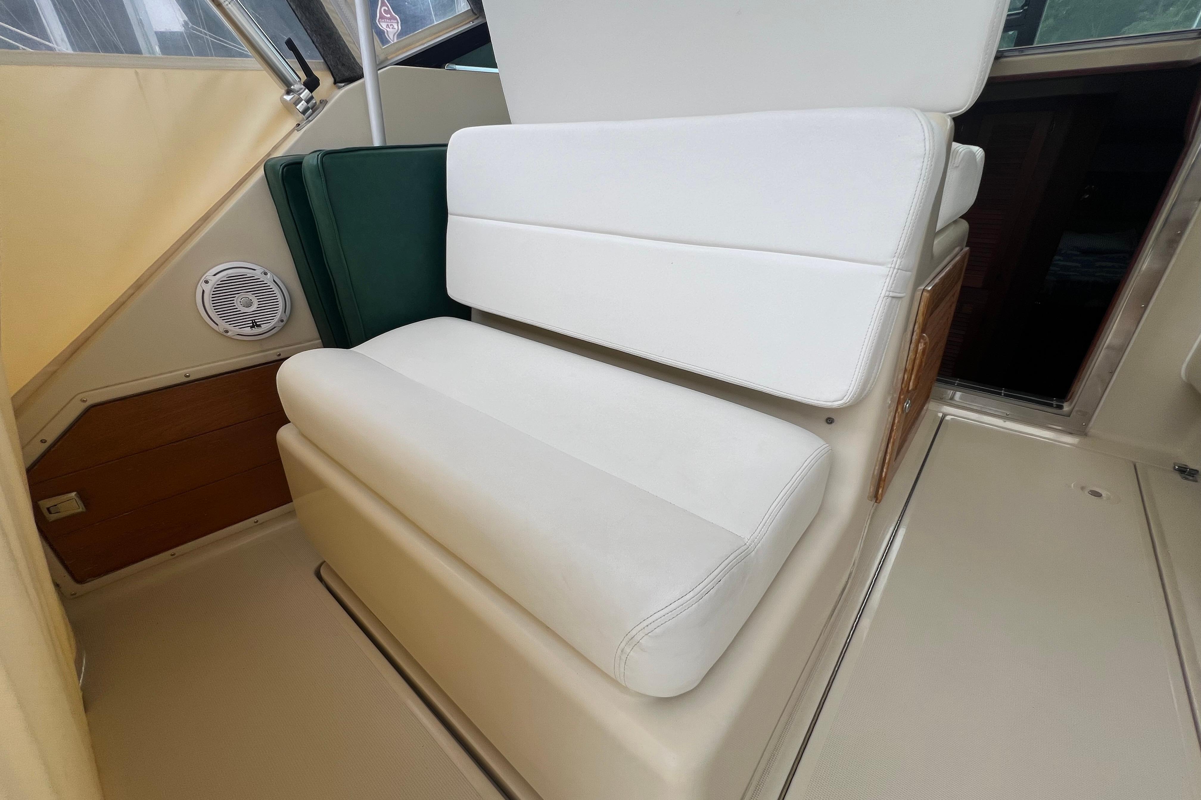 White cushioned seating on 1985 Tiara 36 OPEN boat interior.