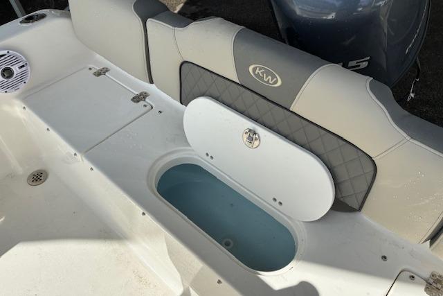 2026 Key West 189 FS boat interior with cushioned seating and storage compartment.