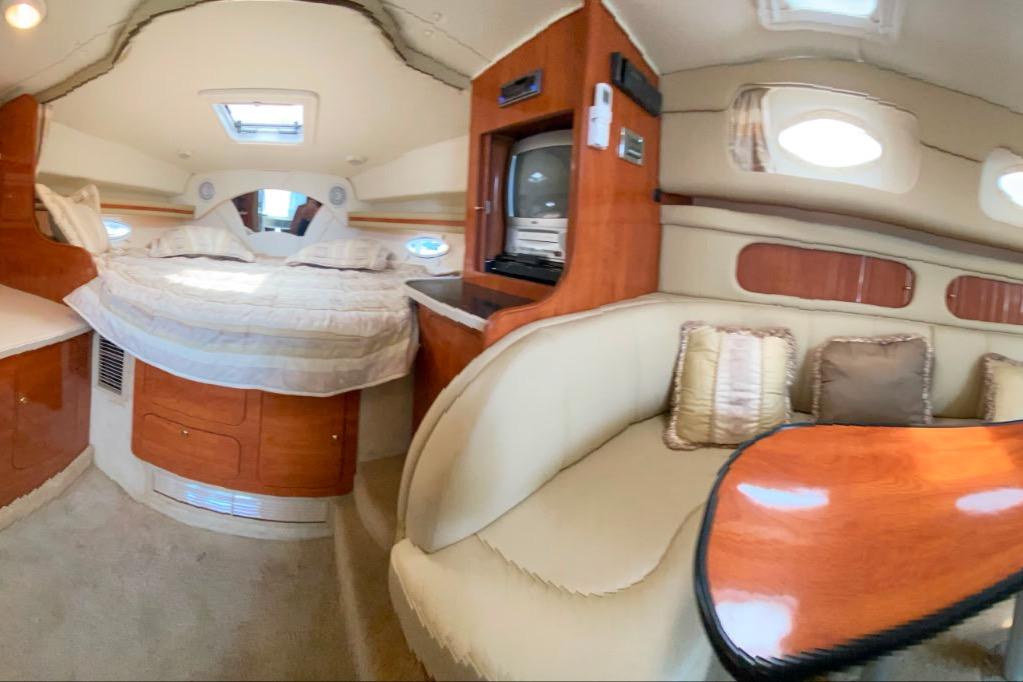 Interior of 2003 Rinker Fiesta Vee 342 yacht with cozy seating and bed.