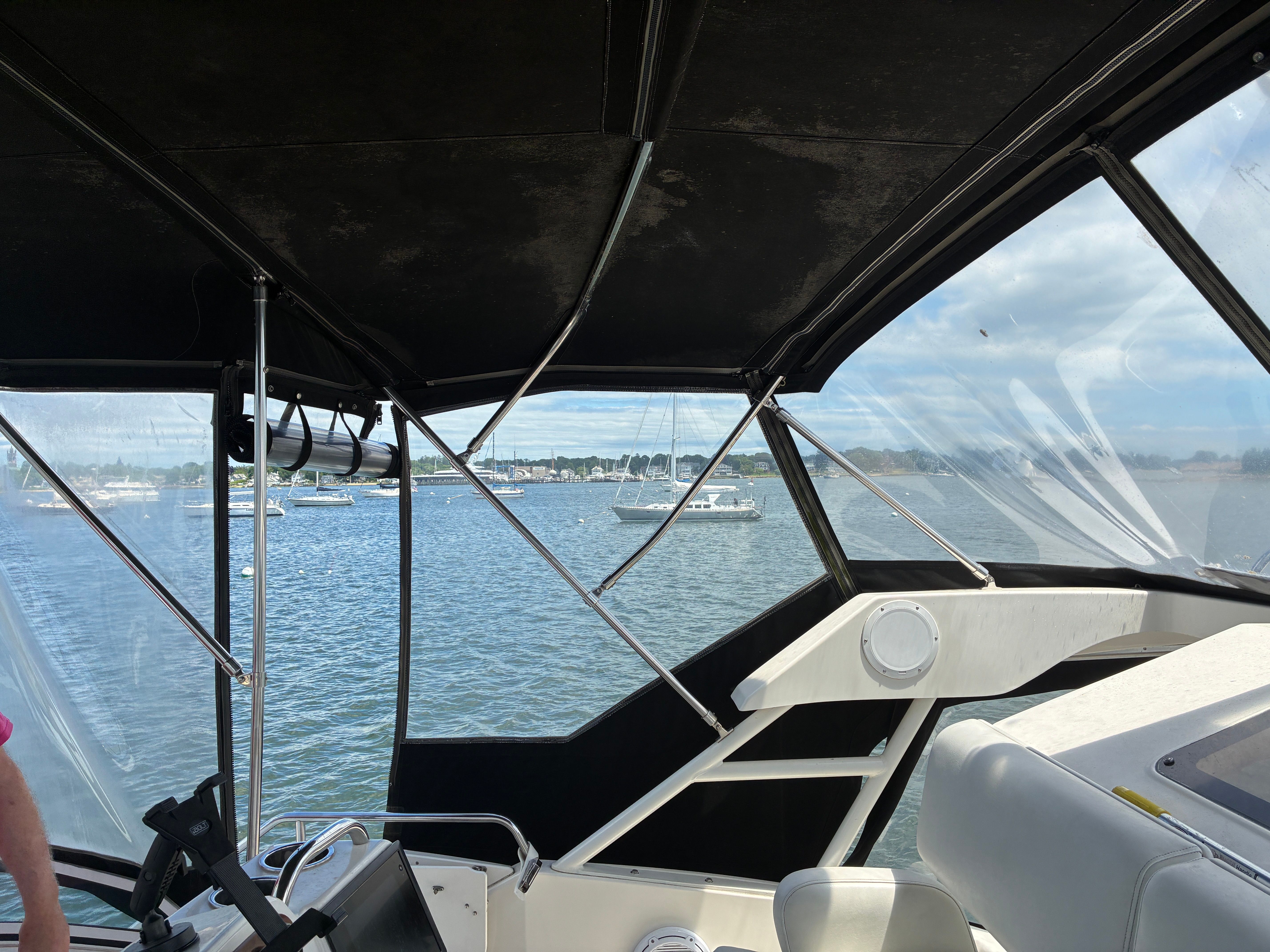 View from the flybridge of a Silverton 392 Motor Yacht overlooking water and other boats.