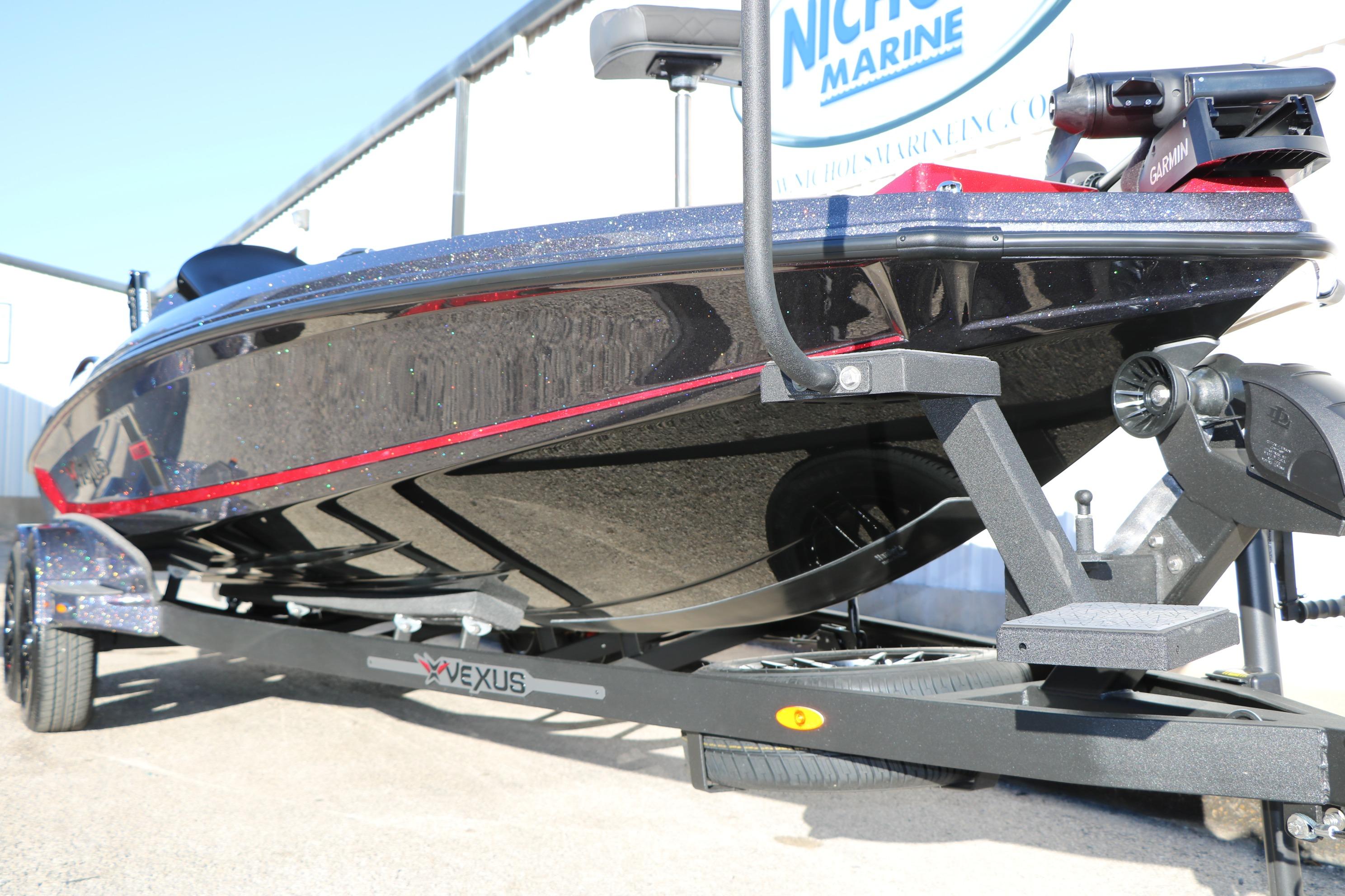 2026 Vexus VXs21 boat on trailer, sleek design with red accents, displayed outdoors.