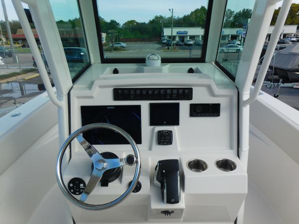 2025 Sailfish 232 CC boat dashboard with steering wheel and control panel.